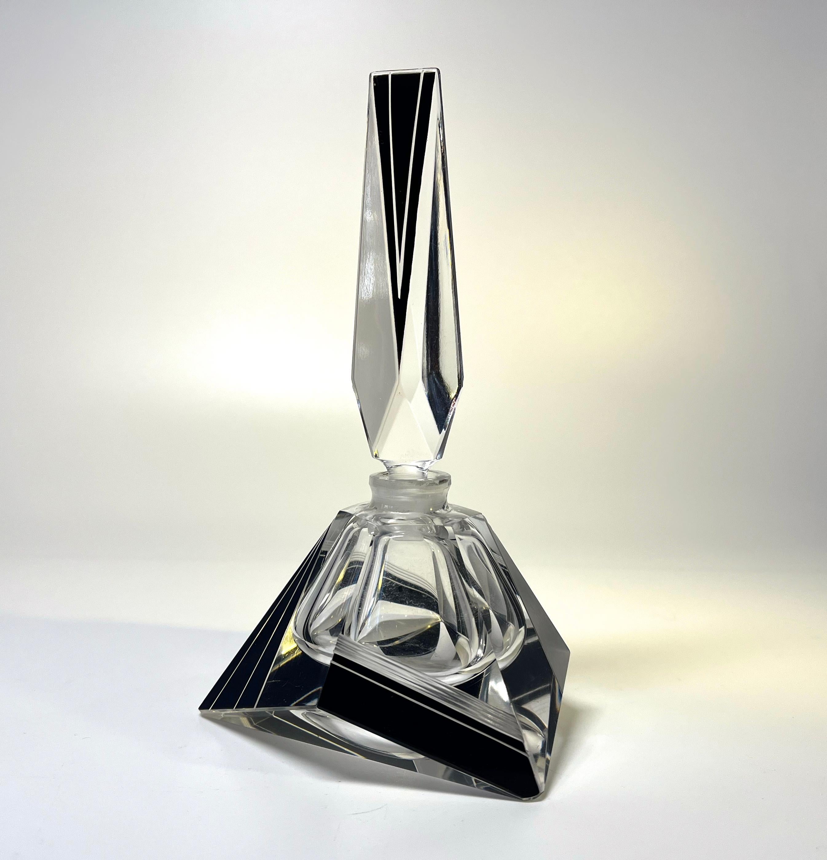 Supreme geometric and angular shaped Czech crystal Art Deco perfume bottle
Clean geometric lines on black enamel. 
Vintage Bohemian, Czech crystal 
Circa 1930's
Height 6.25 inch, Width 3.5 inch, Depth 3.75 inch 
Exceptionally good condition.