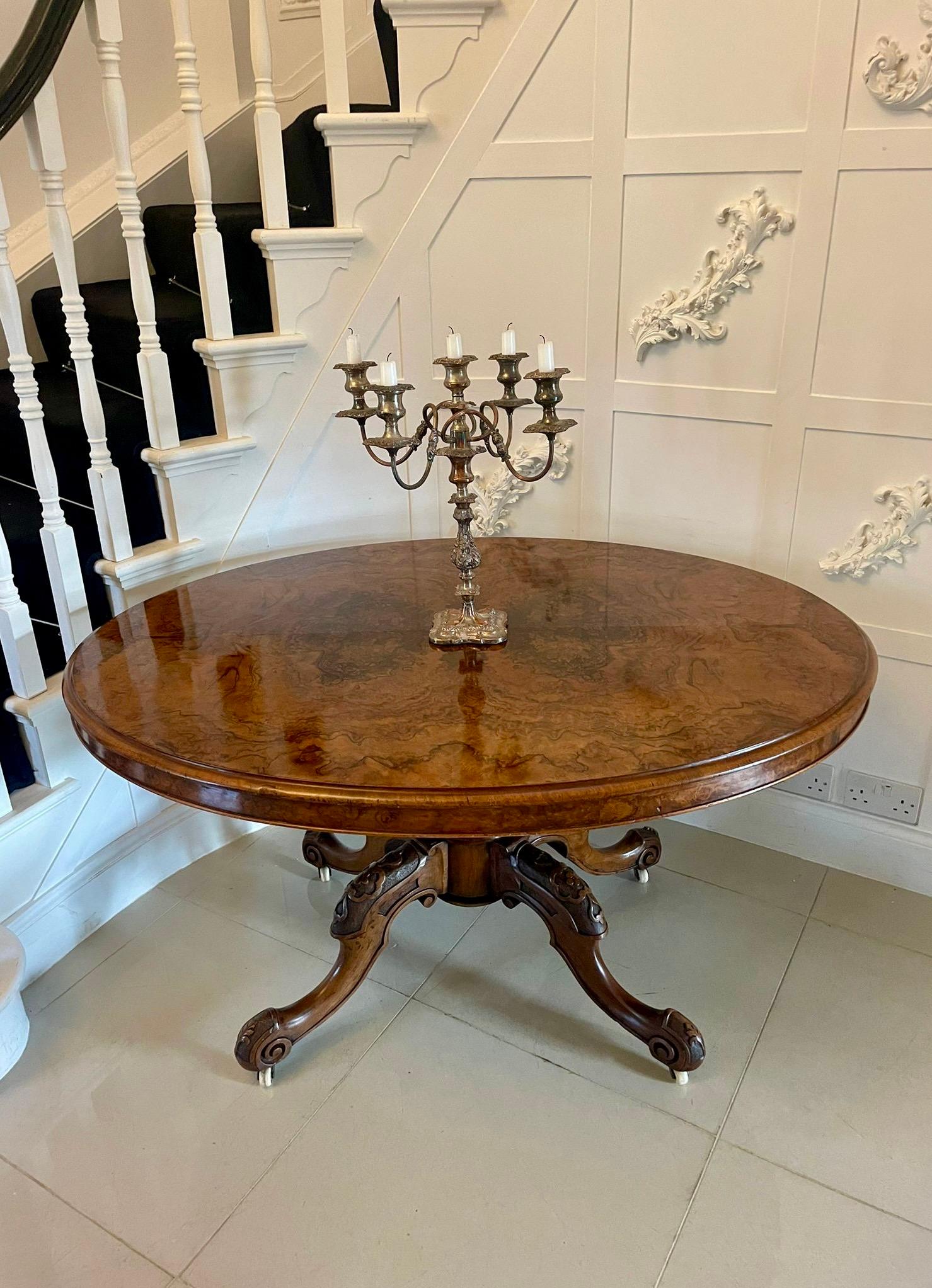 Fine Victorian burr walnut oval centre table having a superior quality oval burr walnut top, a thumb moulded edge and burr walnut oval frieze.  It is raised on a beautifully carved solid walnut column and supported by four expertly carved and shaped