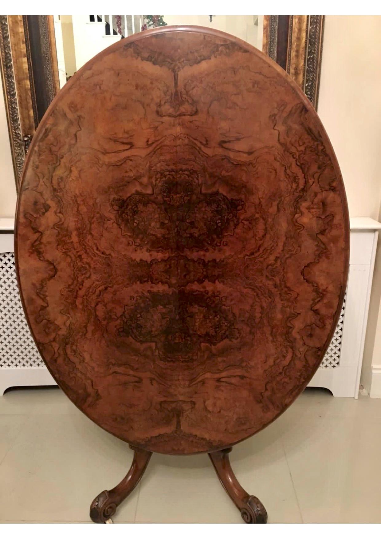 Fine Victorian burr walnut oval centre table having a superior quality oval burr walnut top, a thumb moulded edge and burr walnut oval frieze. It is raised on a beautifully carved solid walnut column and supported by four expertly carved shaped