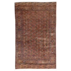 Tapis Bokara afghan ancien, fond rouge et rouille, accents bleus