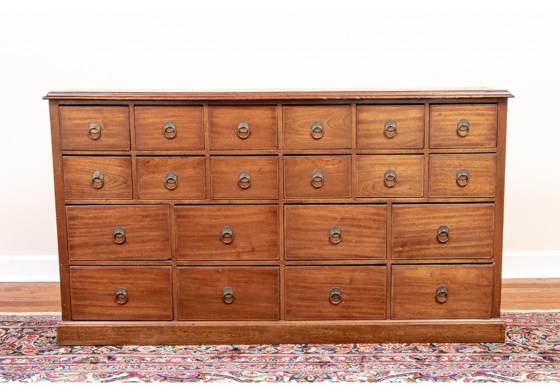 A particularly fine apothecary cabinet in very good condition. A low cabinet with 6 over 6 small drawers over 4 over 4 deeper drawers, all with brass ring pulls. 
Measures: Lenght. 49 3/4