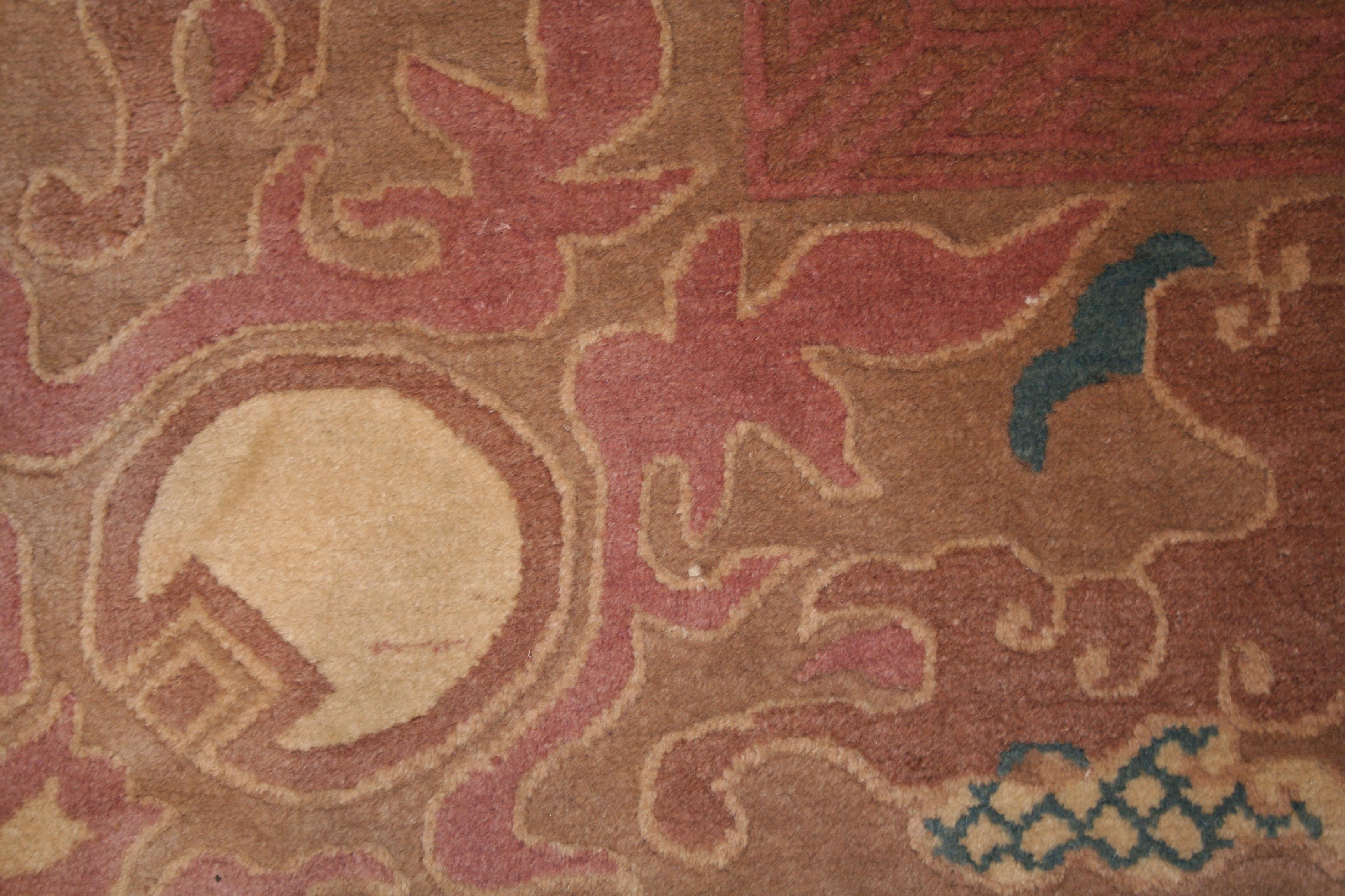 A very finely knotted antique Chinese carpet from the Art Nouveau period distinguished by a tone-on-tone all over design of stylized lotus flowers connected to one another through a network of geometricised leafs. The unusual border is composed