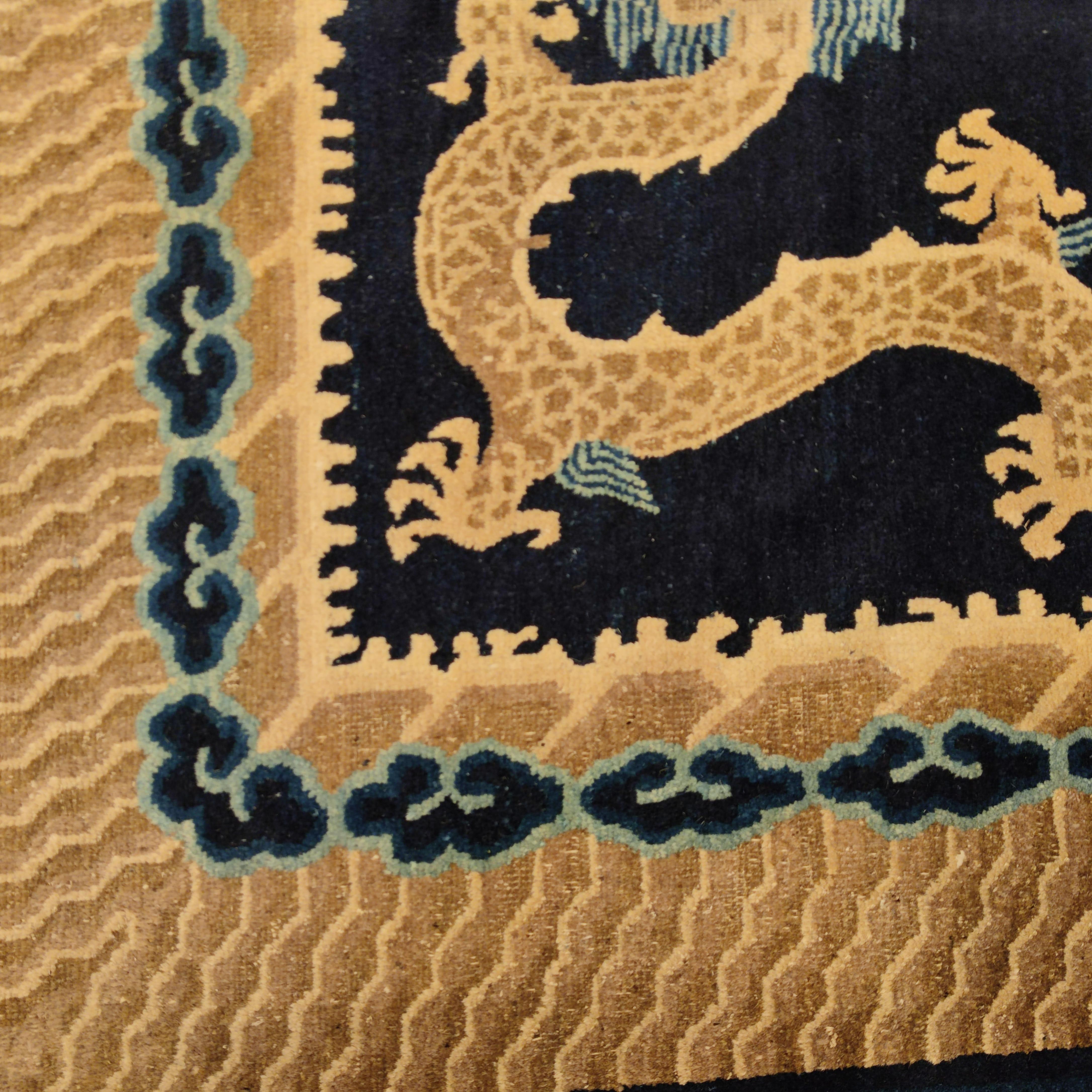 A central, five-clawed dragon (the symbol of both the forces of nature and the Chinese emperor), is surrounded by four other dragons, all floating on an indigo blue background. At both ends a pair of dragons flank a flaming pearl (symbol of wisdom).