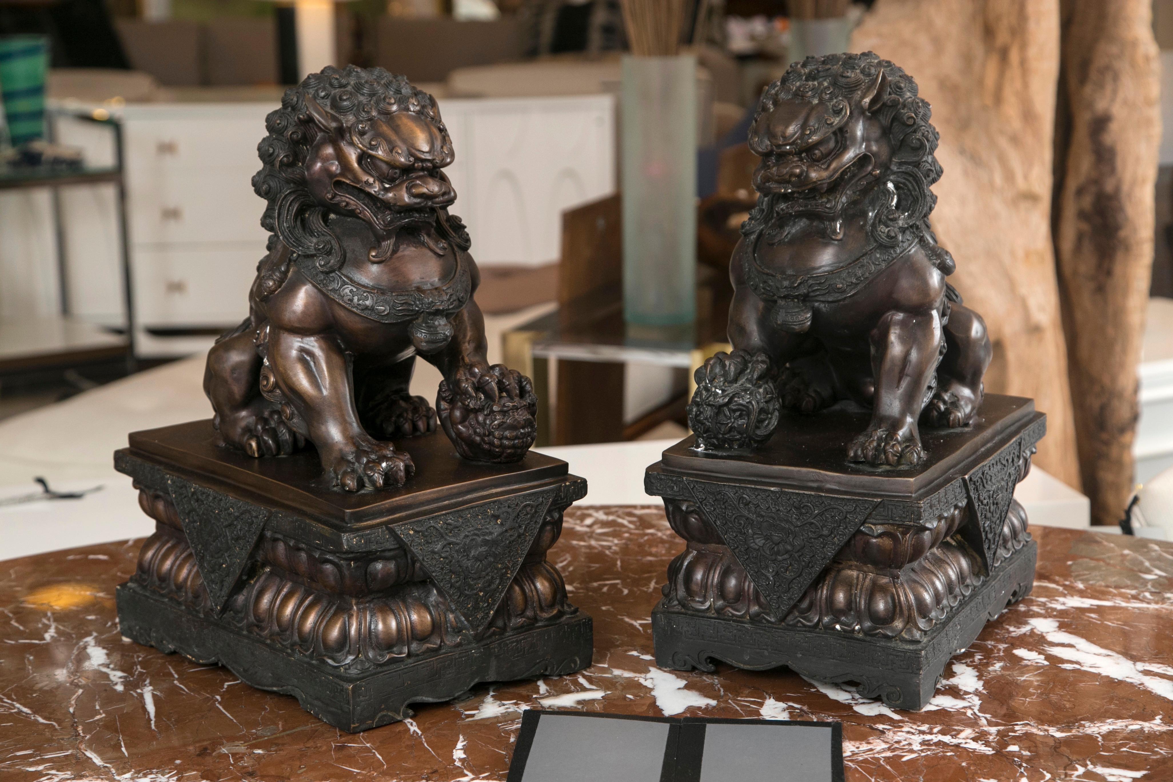 1920's Pair of cast bronze Foo Lion/ Dogs in all original condition. Male and Female, with excellent proportions and a deep, traditional patina. Suitable for any number of Interior or exterior uses.

Chinese guardian lions, or Foo Dogs, are a