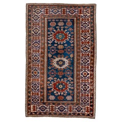 Tapis Shirvan caucasien ancien, champ bleu royal et bordures rouges, vers 1910