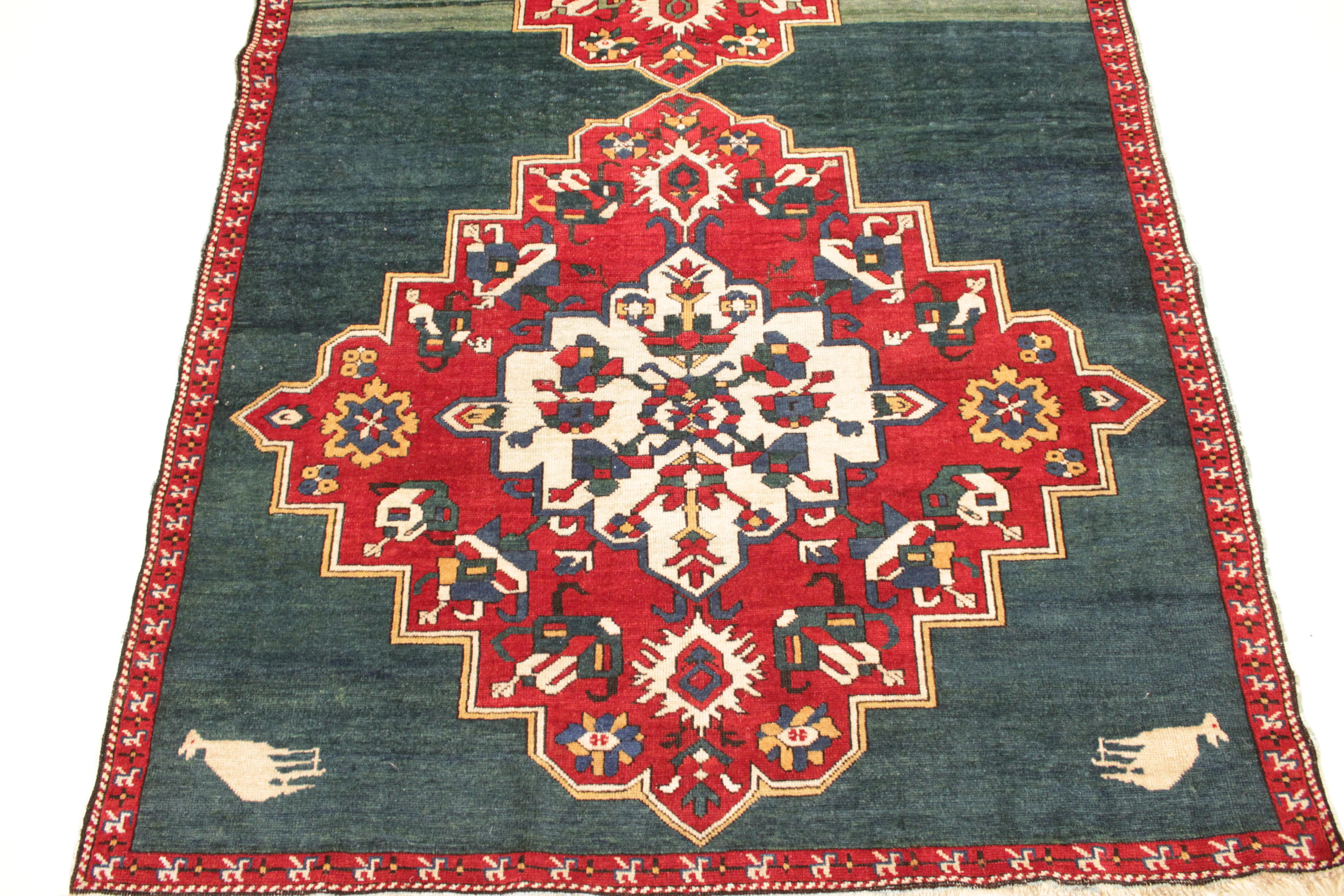 A fine and rare antique Caucasian Zeikhur rug, distinguished by a fairly unique teal green background onto which are layered two red large medallions with abstract zoomorphic elements and with stepped contours, each encapsulating an ivory star-like