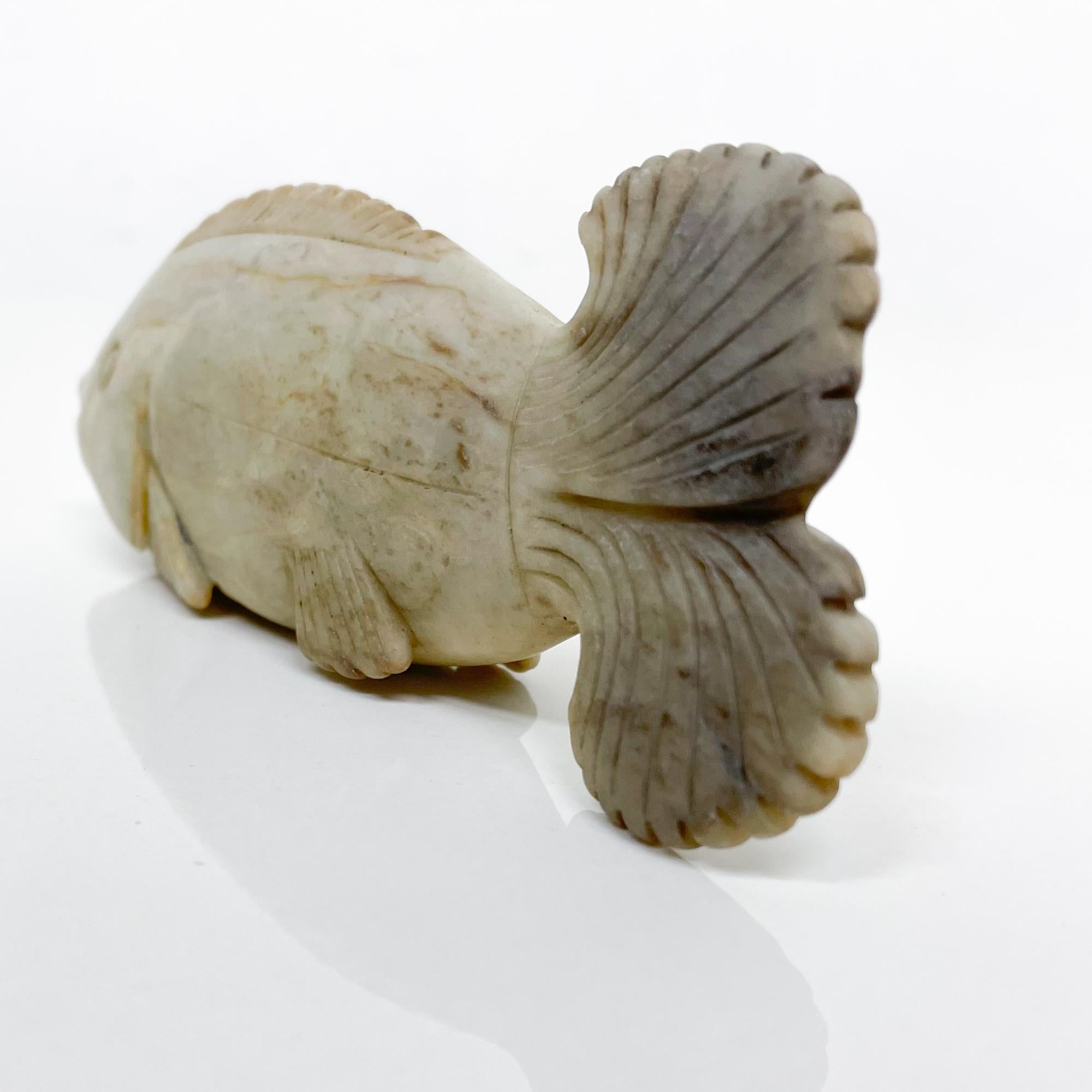 AMBIANIC presents
an antique decorative fish sculpture made in white stone jade.
No markings present from the maker.
Very good vintage unrestored condition.
Refer to images.
Dimensions: 5.13 D x 1 W x 2 H