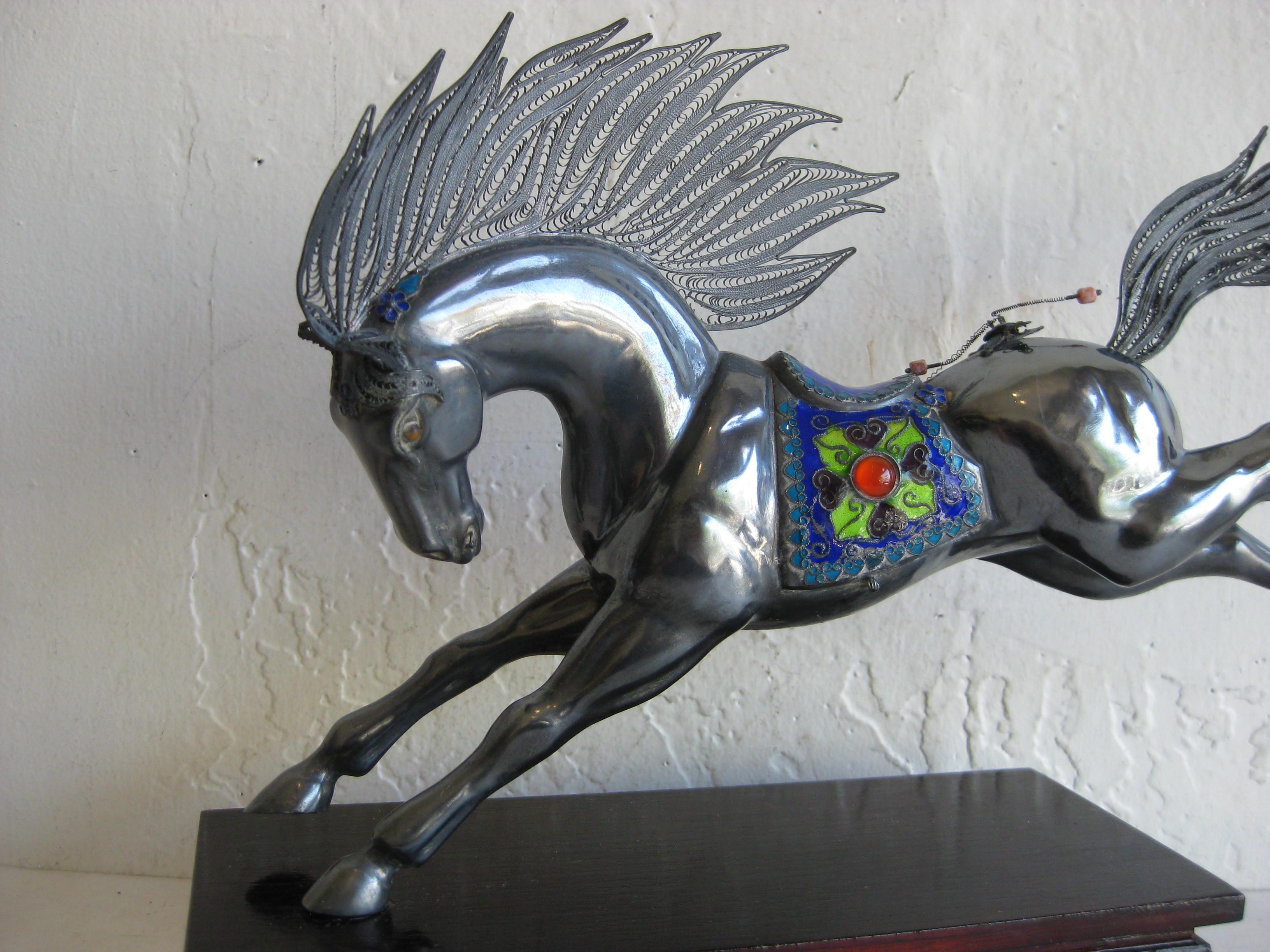 Fine antique Chinese sterling silver and enamel horse sculpture mounted on a lacquered wood stand. The horse is made of sterling silver and is made well. Has enamel decorations as seen in the photos. Also coral beads as decorations. Missing one