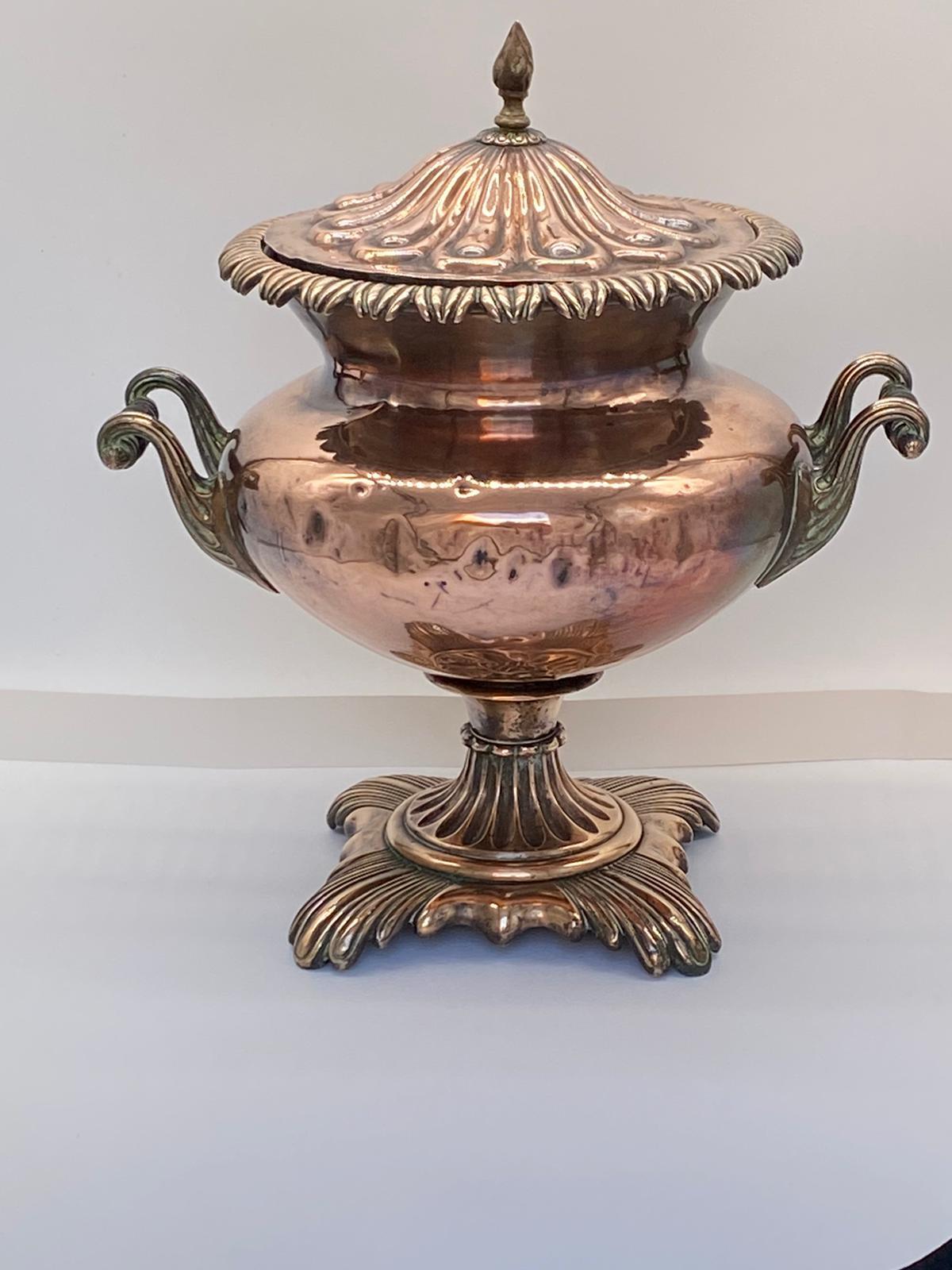 Fine Antique Copper Samovar with a lidded top above a body flanked by hands and a tap to the front above a gadrooned base.