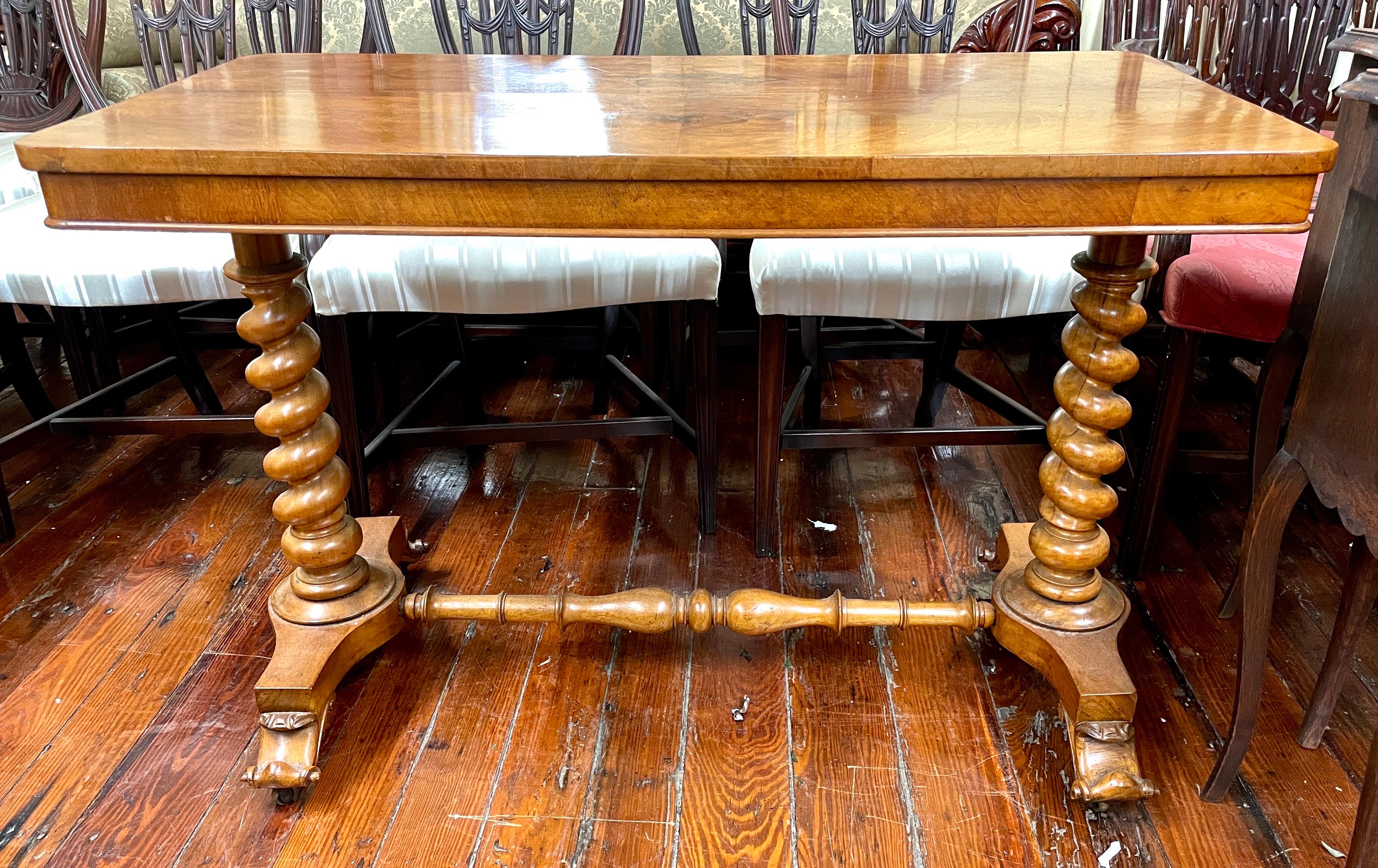 A Terrific mid 19th century Antique English burr walnut Library Table or Console Table (or Side Table!) with exceptional barley twist legs that support the top terminating in a lovely turned baluster shape stretcher and ending in a platform