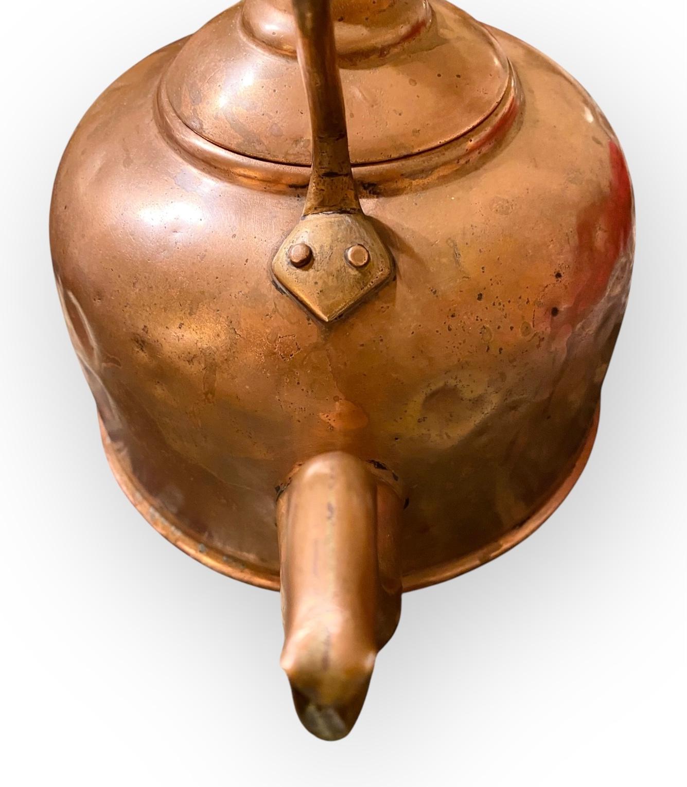 A fine antique George III copper kettle with a shaped handle, spout and lift off lid. A beautiful patina that only comes with age and many years of loving use. 
This stunning copper piece would be a statement in your kitchen, breakfast room, or