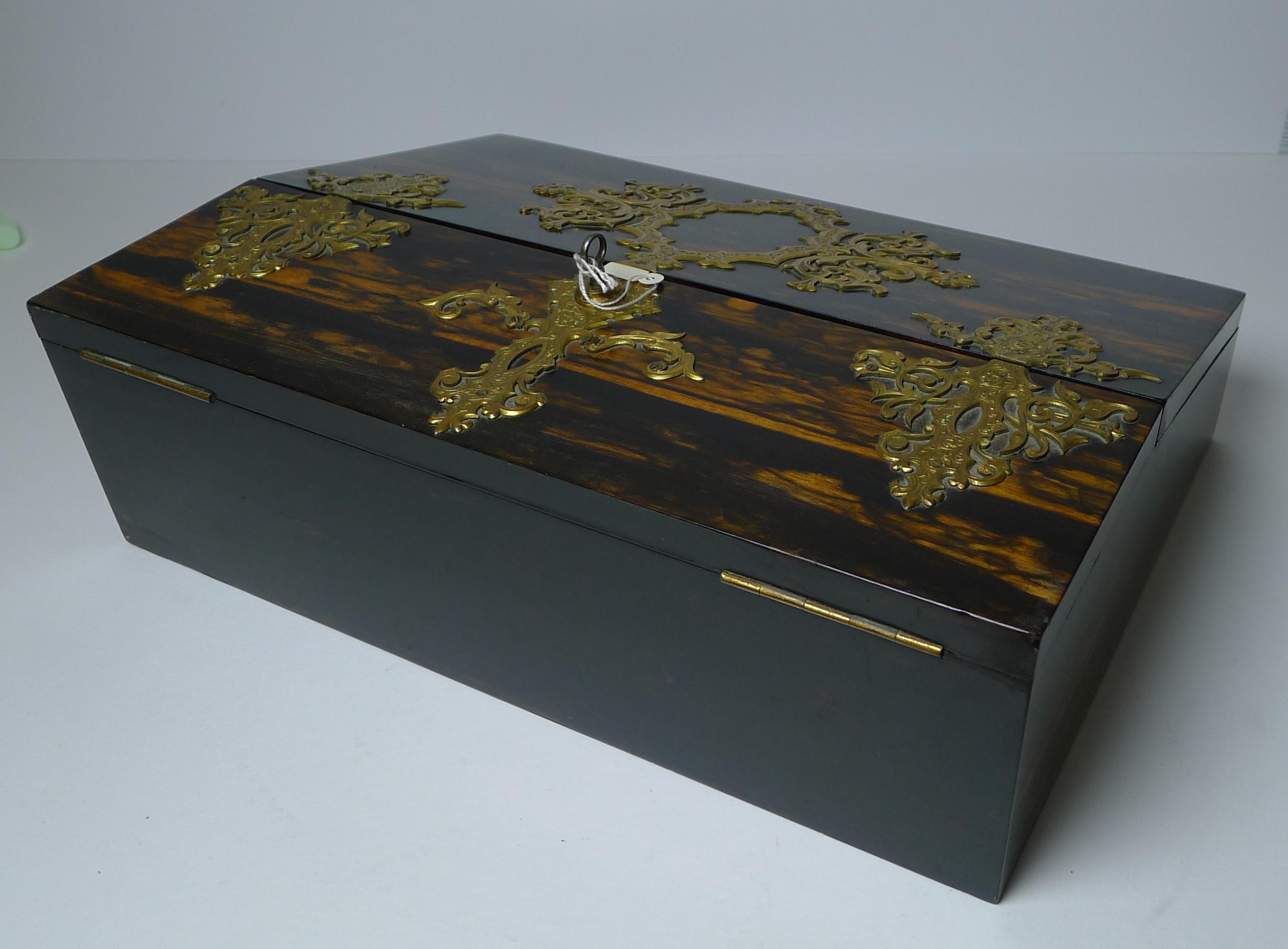 A superb quality Victorian writing box / slope in exotic and dramatic Coromandel wood mounted with the most exquisite gilded bronze mounts, all intricately engraved with top-notch screwed mounting.

The box comes complete with the original working