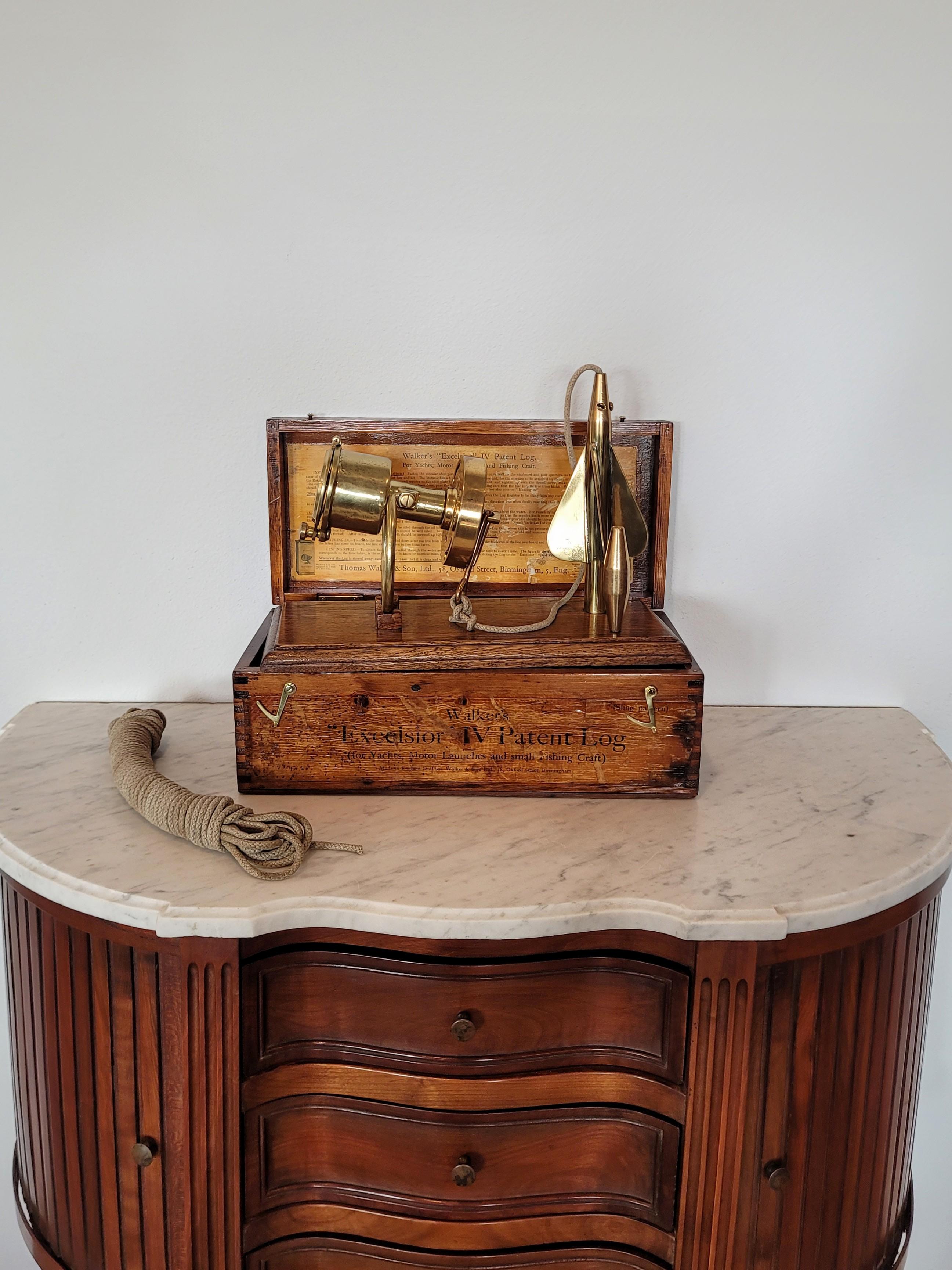 A highly collectible and sought-after antique Walker's Excelsior IV Patent Log, circa 1920s/1930s, signed solid brass Nautical outrigger with register, flywheel rotator, and accessories, stored in the original varnished pine wood box, includes later