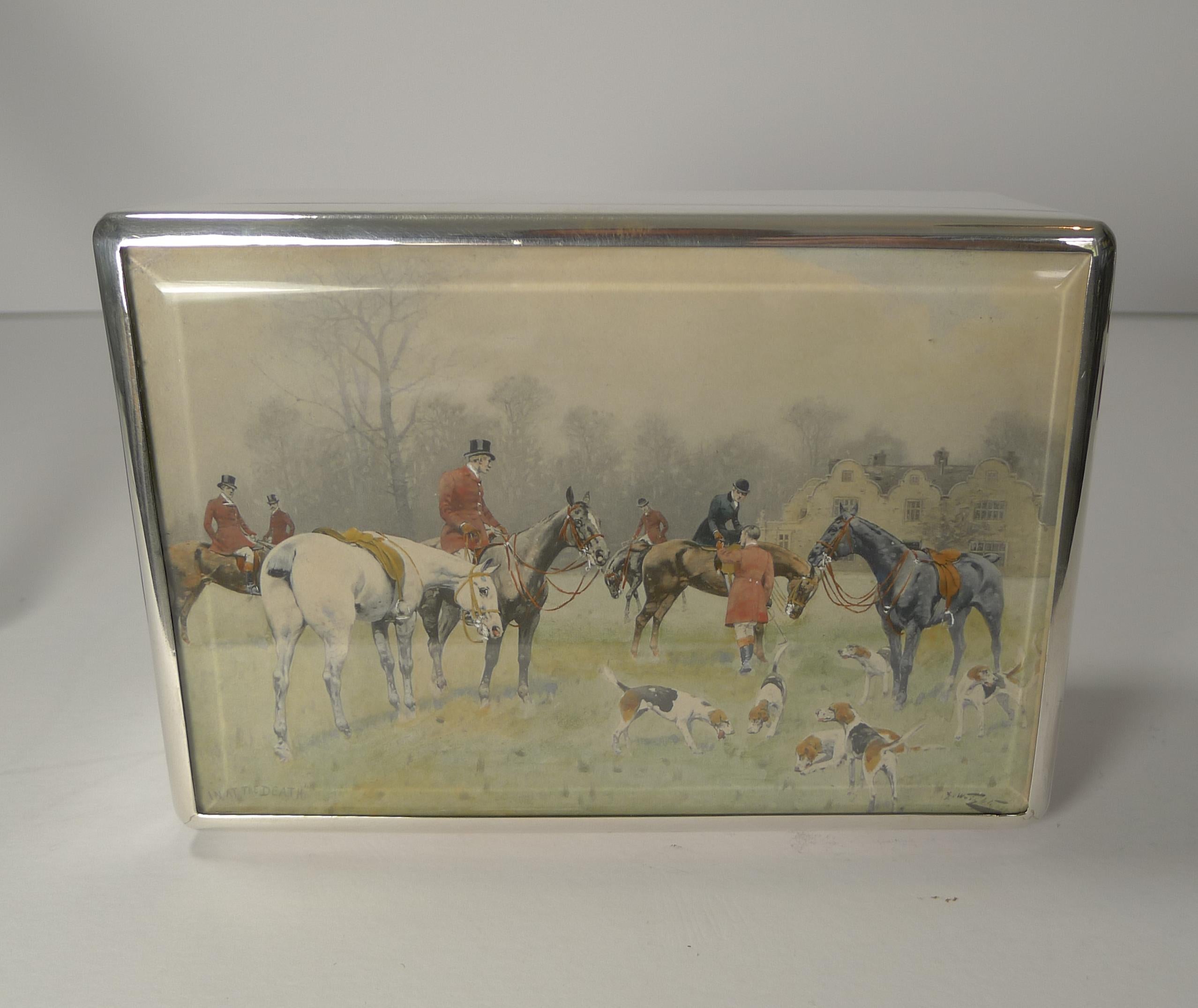 A top quality example of an early Edwardian cheroot or cigar box made from sterling silver with the original beveled glass lid protected the hand-colored George Wright print titled 