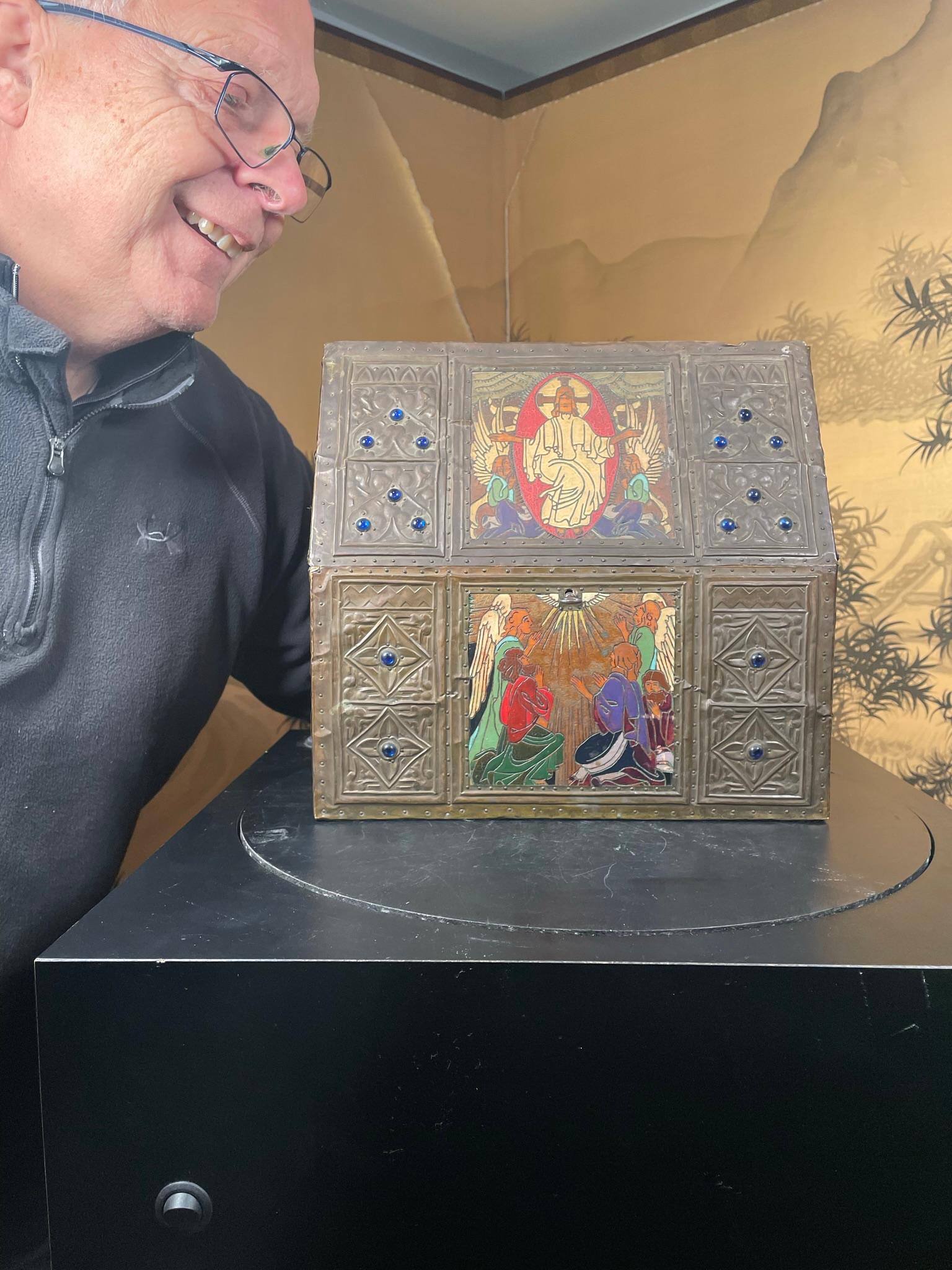 From an old French collection.

A fine hand crafted wood and repousse holy reliquary box of angular architectural form depicting Christ in Majesty , angels, and desciples on six surroundinig panels. Each panel is hand burned and polychromed in