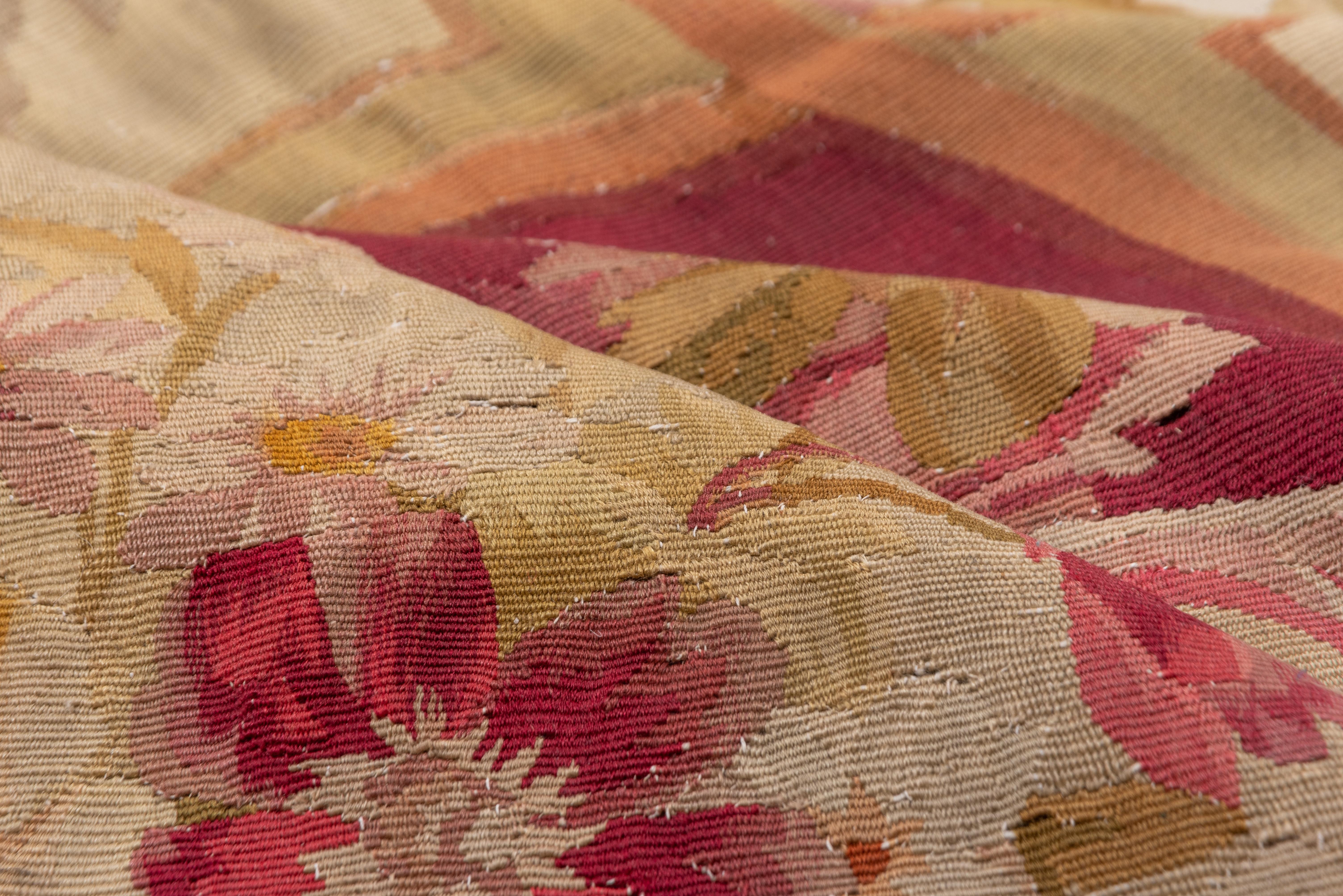 Four bouquet-centered corner cartouches anchor emphatic giant dark brown pointed L-shapes. The small eggshell field is gently convex or lobed and shows the inevitable rose bouquet in the center. Good condition for this antique French tapestry-woven