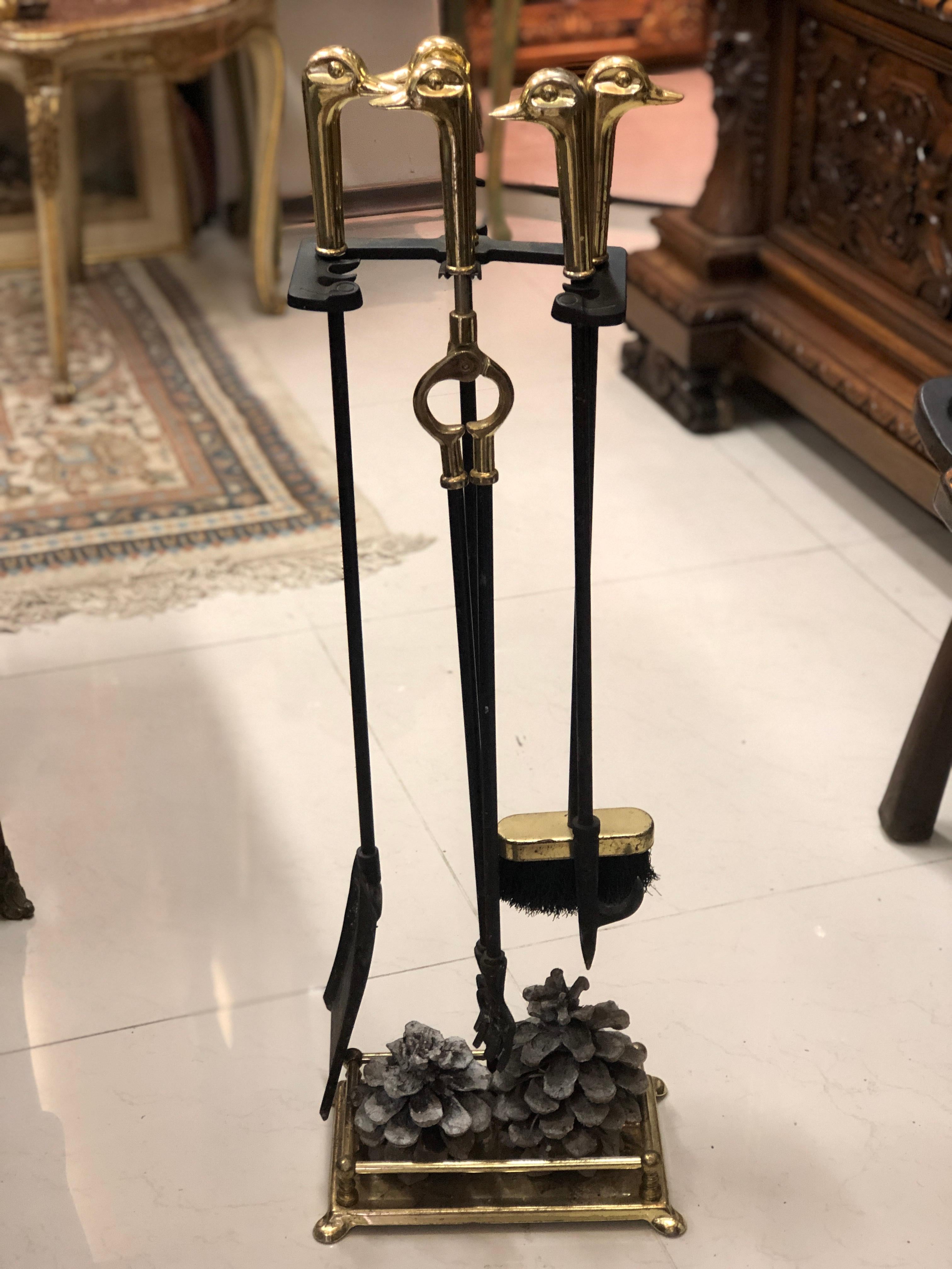 A fine antique French fire place tool set and stand with beautiful bronze duck heads handles.
France, circa 1900.