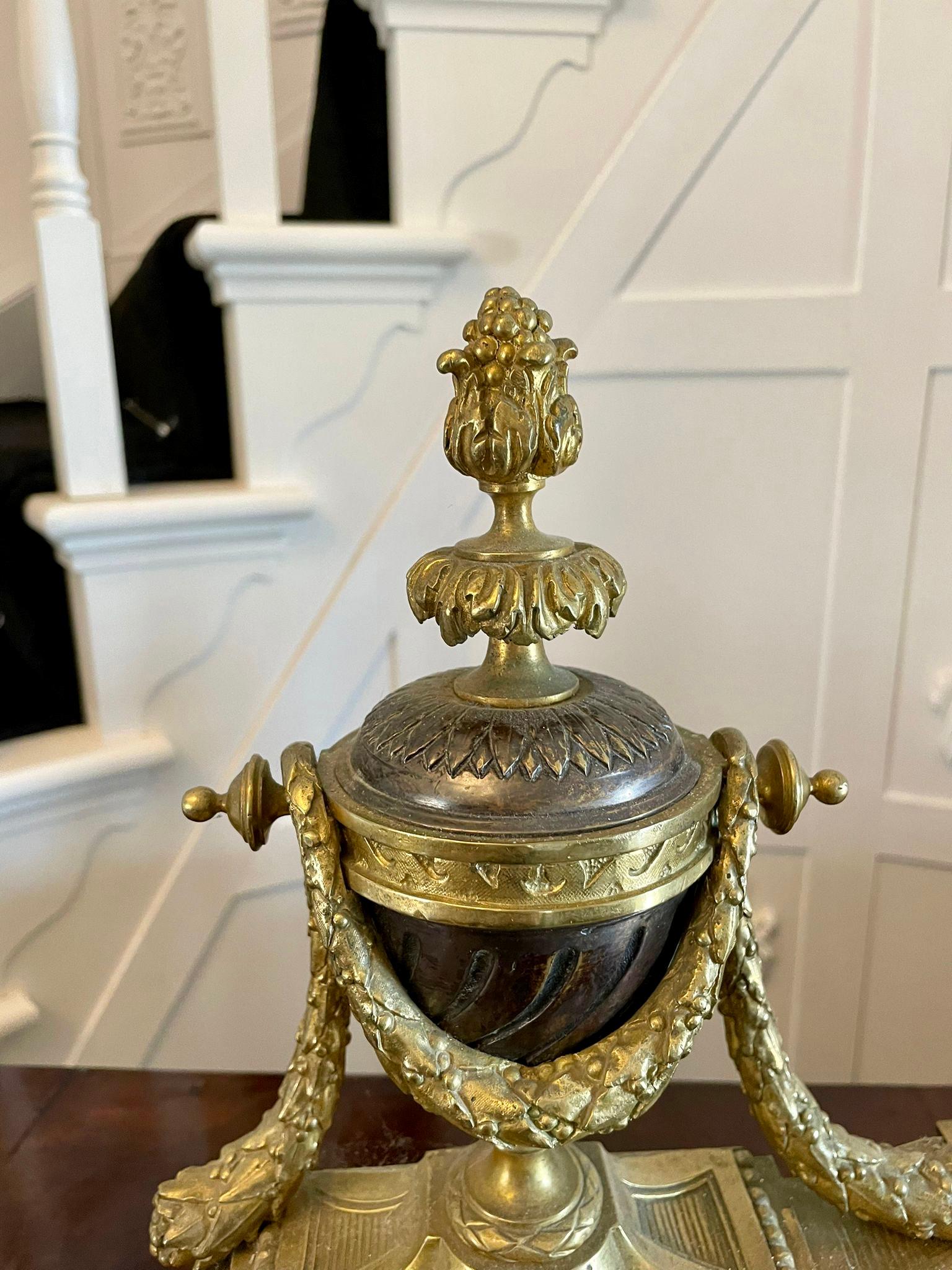 Fine French antique classical gilt bronze ormolu extending fender having outstanding slit, helix and star decoration to the front with a pair of fantastic two tone bronze urns with cameo intaglios and finial tops with ornate shaped feet. Stamped to