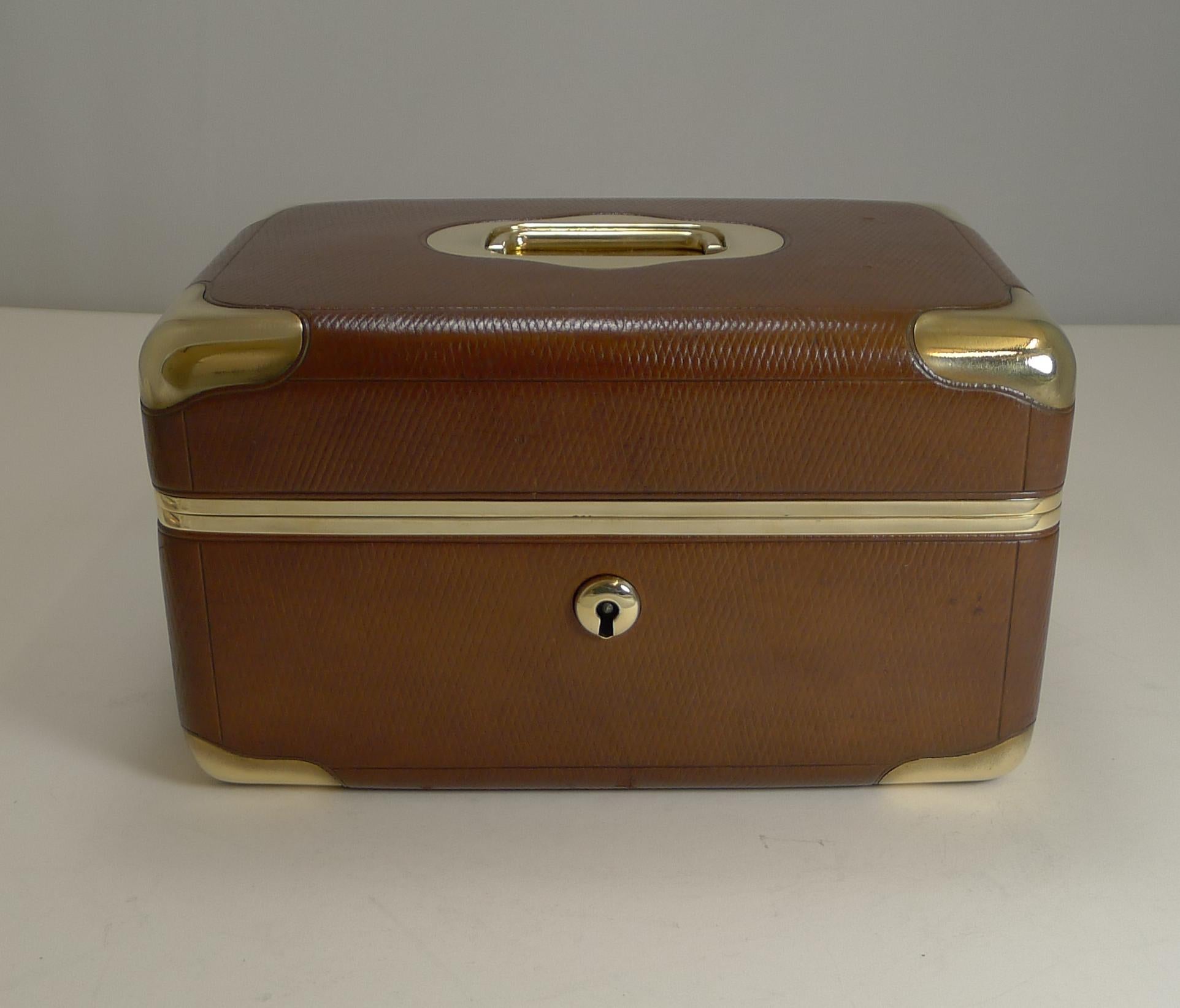A superb quality box in the style of S-trunk with solid brass corners and a flush campaign style carrying handle inset to the lid.

The box comes with working lock and key, and once opened there is a retailer's signature from Algeria; 