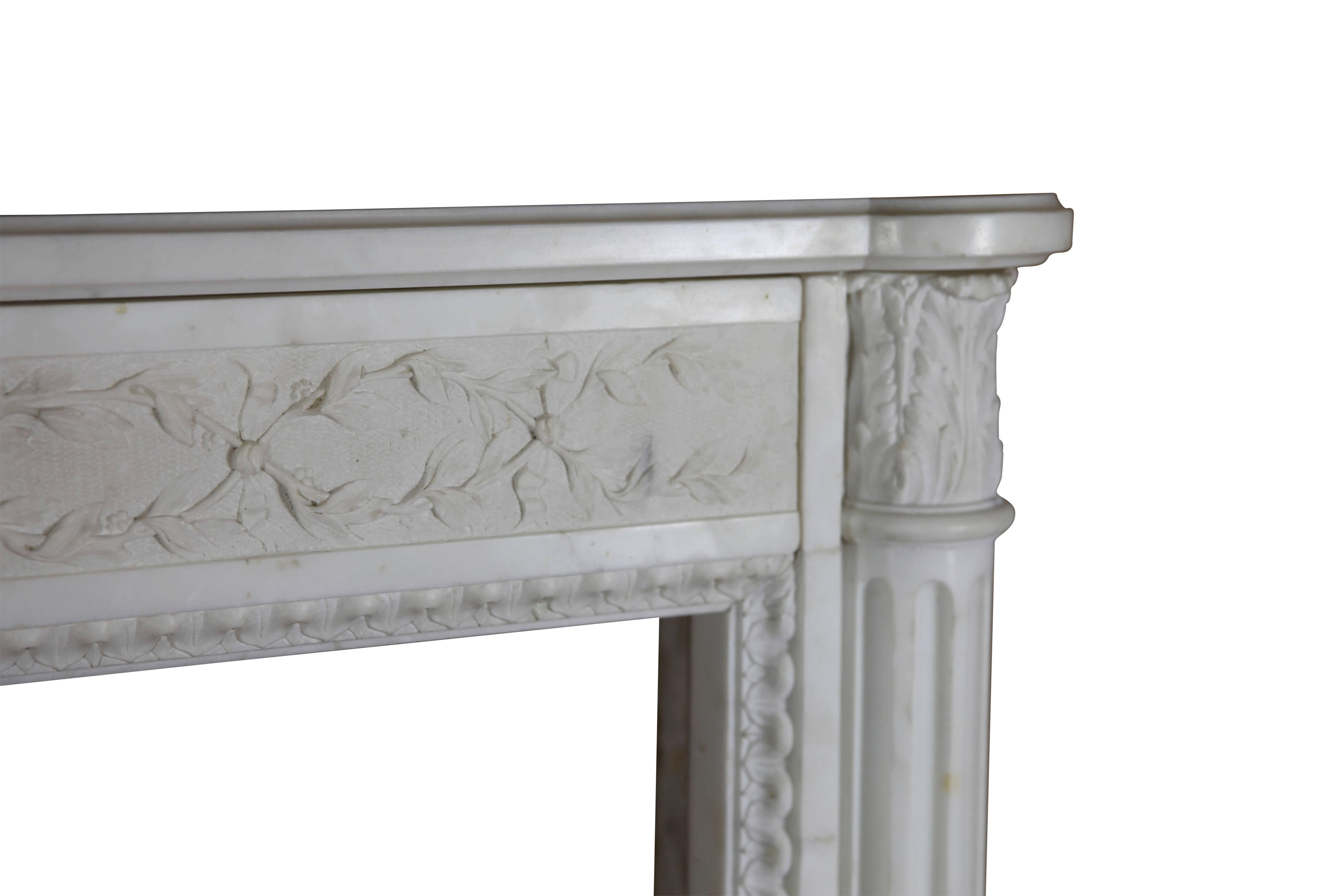 This small vintage fireplace surround in white statuary marble is a very unique piece. This mantel would perfectly fit in American colonial style interior as well as in a modern or even a contemporary interior design. A high-end chimney piece for a