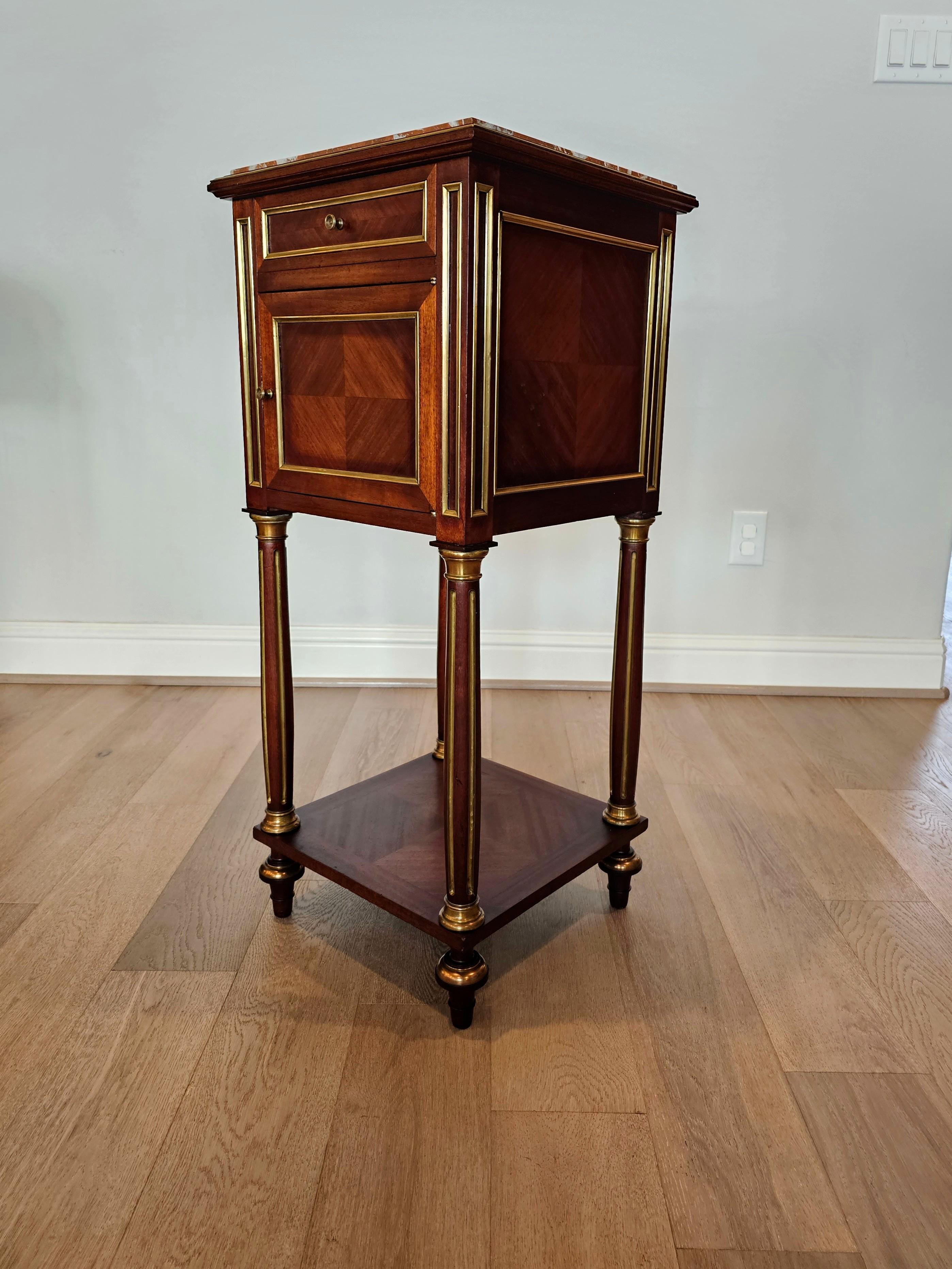 A fine quality antique French Parisian marble-top mahogany bedside cabinet, circa 1890.

Exquisitely hand-crafted in France in the late 19th century, exceptionally executed in refined luxurious Louis XVI taste, having a rouge marble top framed by