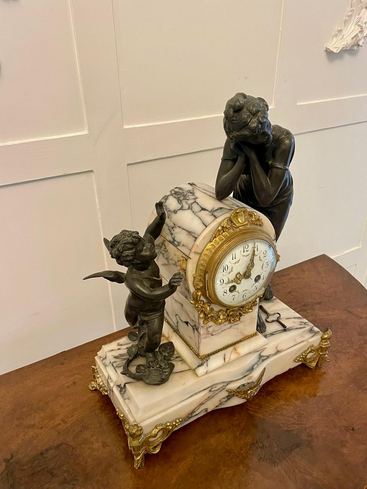 Fine antique French marble, bronze and ormolu striking mantle clock having two magnificent quality bronze figures one being a lady in period dress the other of a standing cupid either side of a fine eight day French clock which strikes on the hour