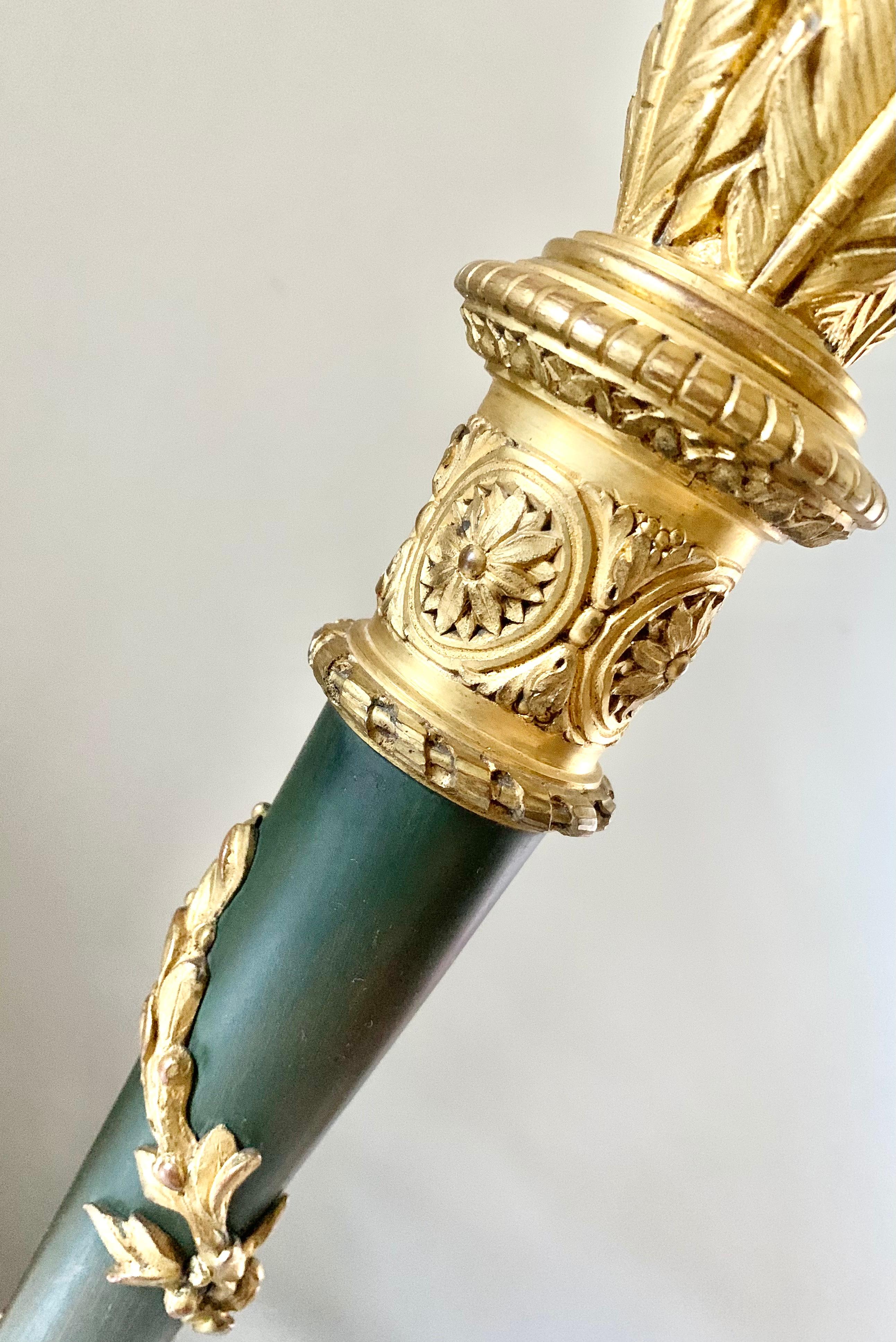 Exceptional quality, attributed to Maison Gagneau, Paris gilt and patinated bronze desk lamp designed as a quiver of arrows in the Neoclassical taste. Circular base with laurel leaf wreath motif supporting a patinated bronze flaring quiver with a