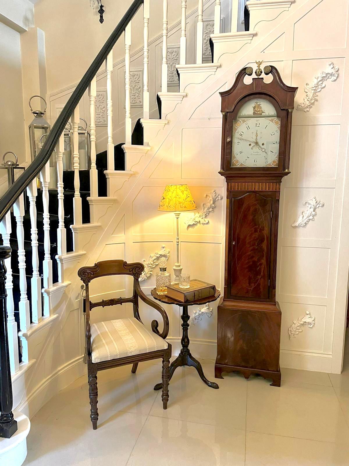 Fine antique George III inlaid mahogany eight day longcase clock having a shaped swan neck pediment above an arched glass and mahogany door flanked by reeded columns, satinwood inlaid frieze above a quality figured inlaid mahogany door flanked by