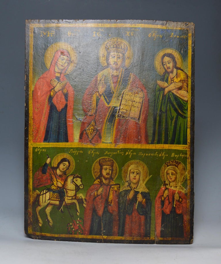 Fine Greek icon of a saint
A fine old Greek Icon on wood board dating from the 18th or early 19th century
A very beautiful fine and captivating icon of Jesus, saints, worshipers and St George killing the dragon
All original with no