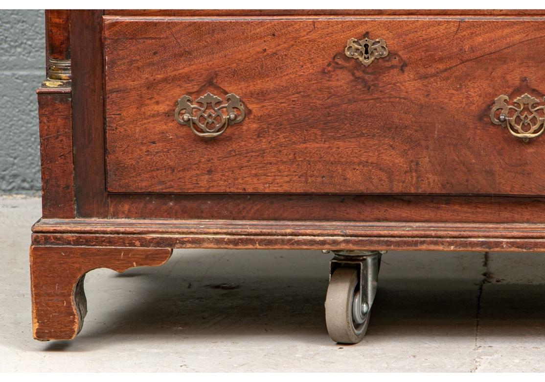 A very handsome 19th century dresser with great graining and fine form. Raised on a Chippendale style platform with quarter round columns at the sides and having solid brass batwing pulls. Wheels in photo are a carrying dolly.
Condition: There are