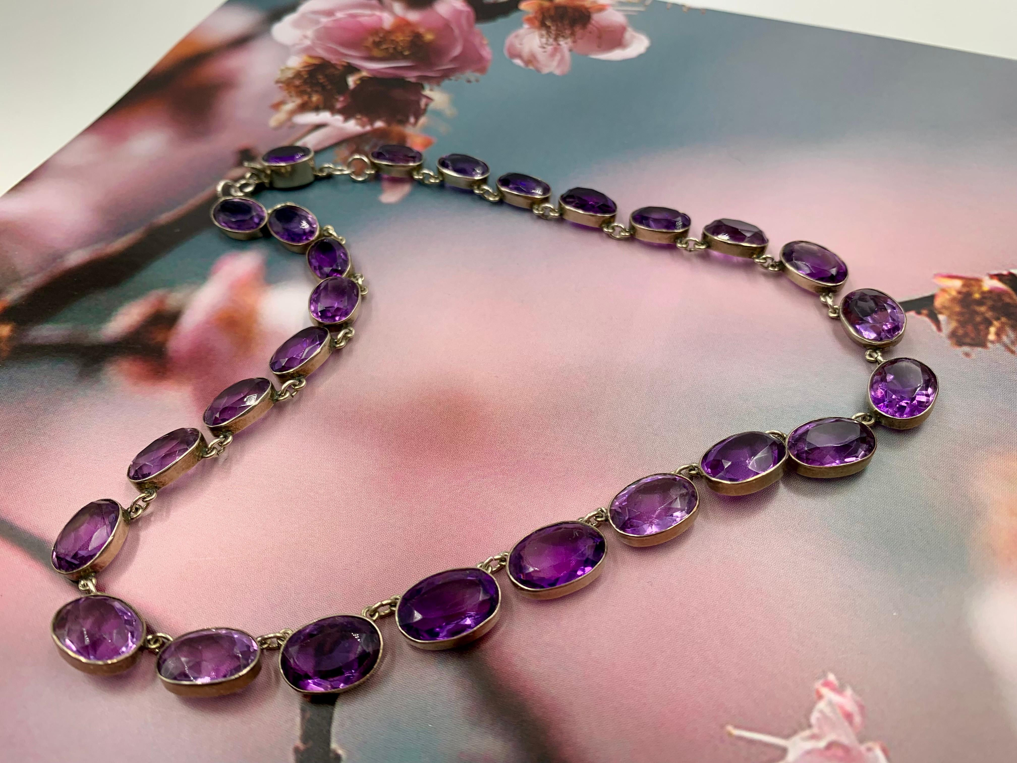 Fine antique natural facet cut graduated oval amethyst and silver Riviere necklace
19th Century
Composed of twenty six natural oval facet cut graduated purple amethysts set in silver. The amethysts gemstones well matched, lively, hand faceted, of a