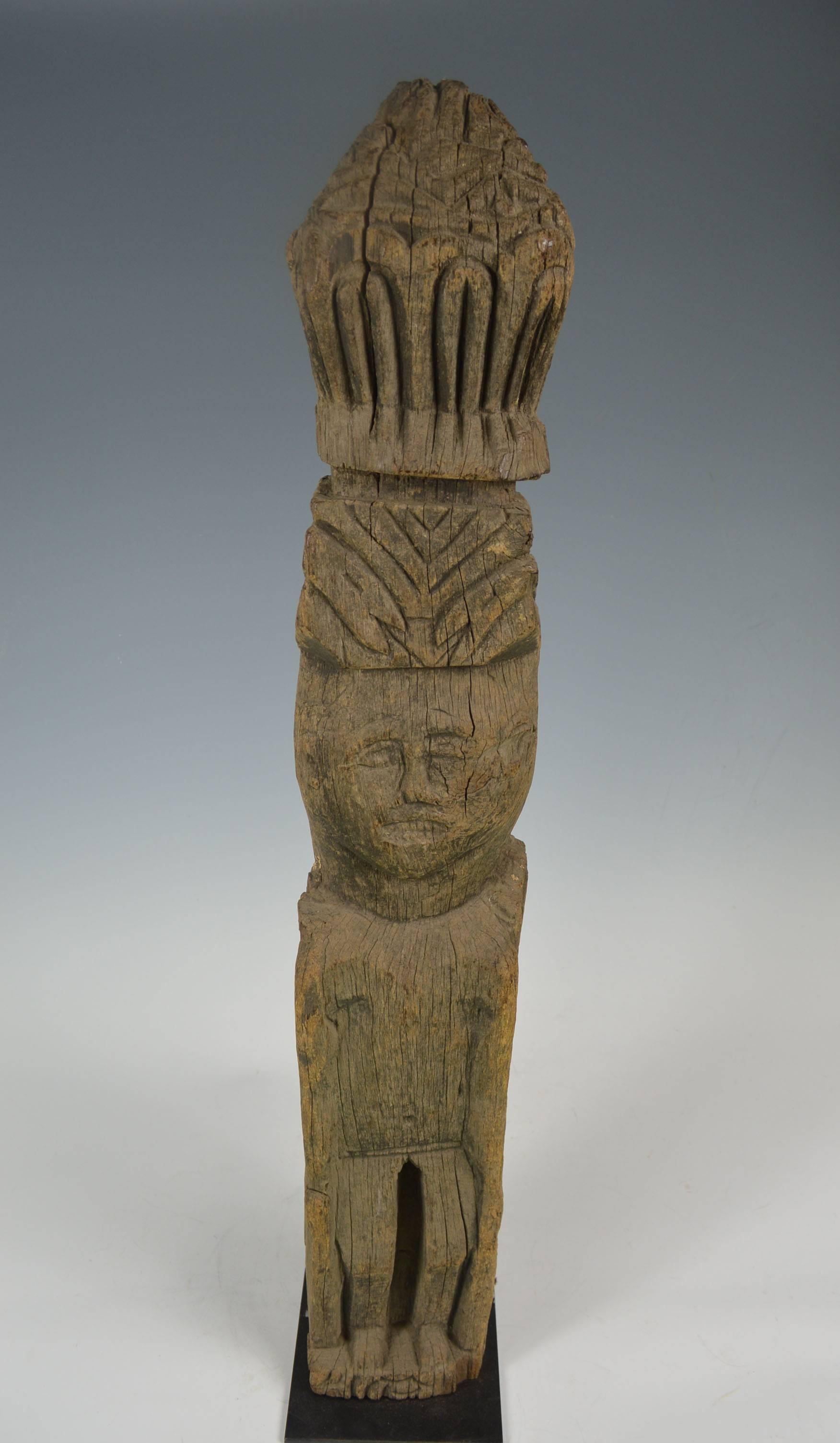 Himalayan west Nepal tribal house post figure
A very old hard wood post the front with standing primitive figure surmounted by a carved finial, the back with carved tantric symbols
Size 92 cm on metal base
Period early 19th century
Provenance: