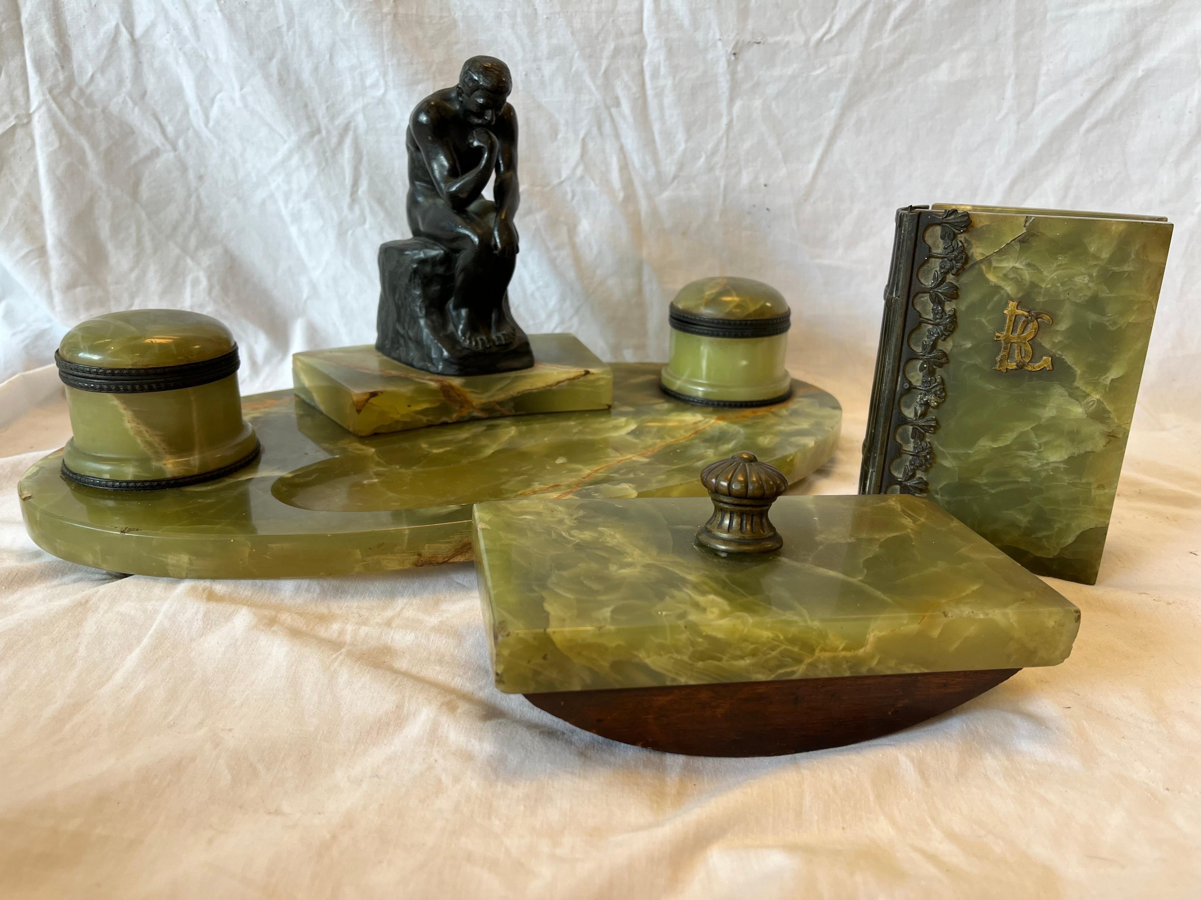 A fine and antique onyx and bronze desk set featuring a sculpture of Rodin's Thinker done by Hungarian sculptor Andor Ruff. From the AskArt website, 