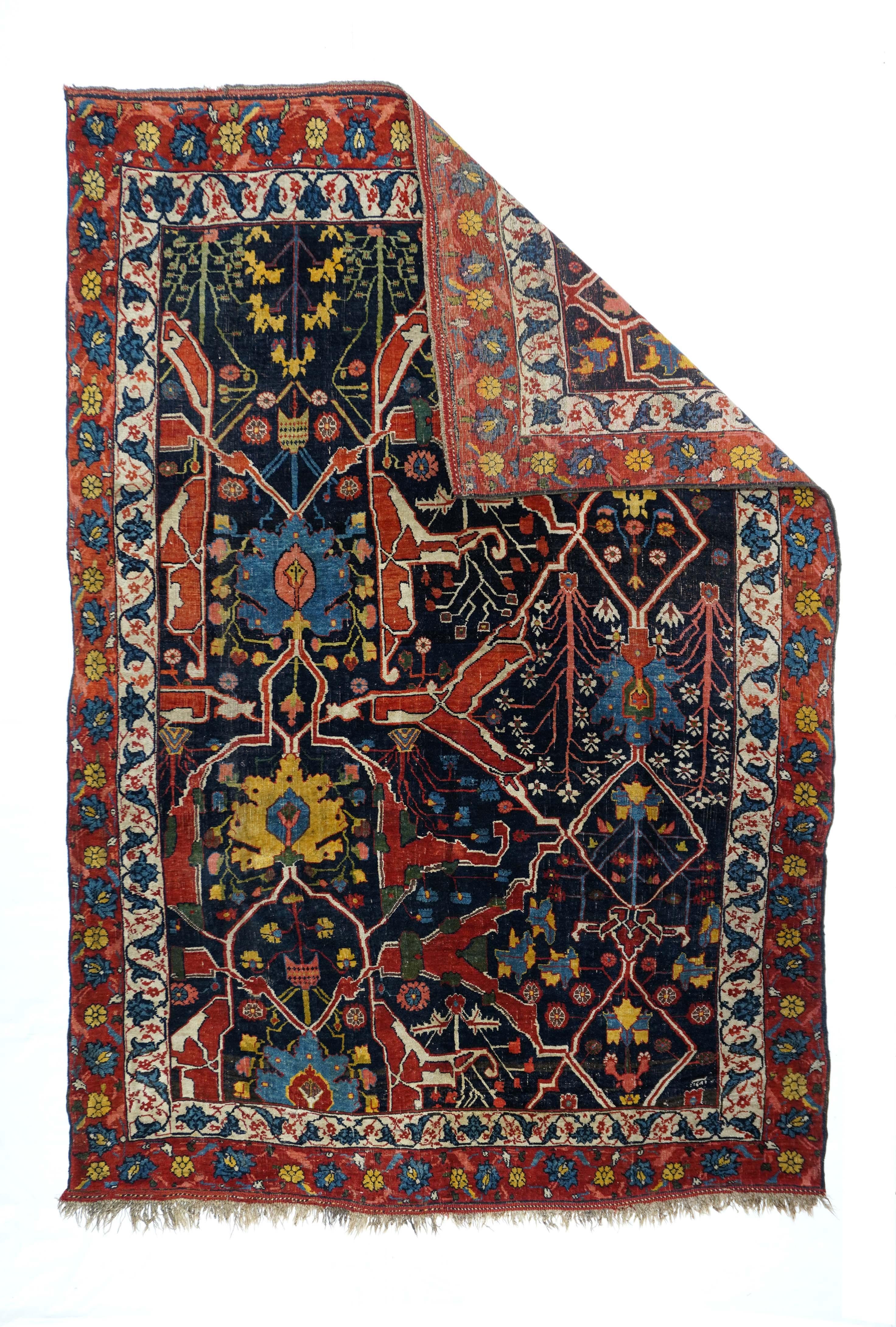 This large, Kurdish urban scatter from the Bidjar-origin town of Garrus shows an offset, partial rendering of the eponymous design of red and cream forked, geometric arabesques, ragged palmettes and small upright flowers on a navy indigo ground.