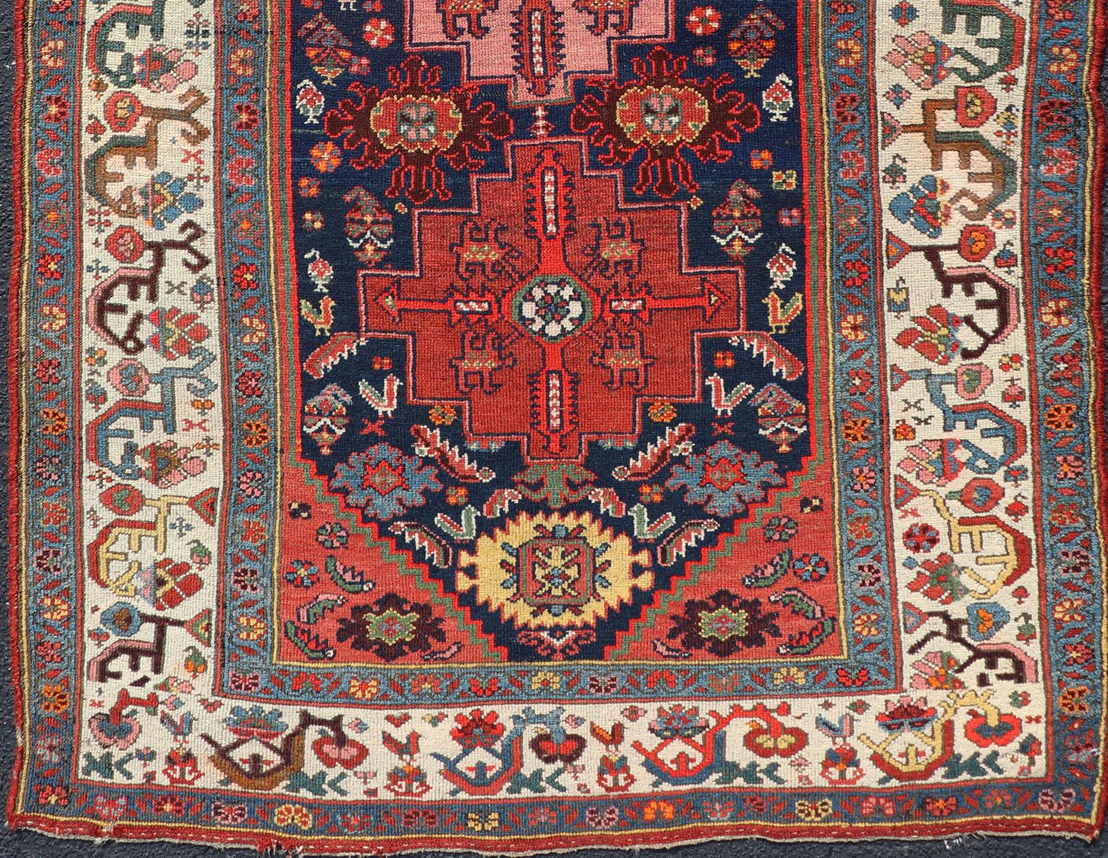 Rich vegetable colors in Blue and red Tribal Medallion design fine weave Kurdish antique rug from Persia, rug R20-0503, country of origin / type: Iran / Kurdish, circa 1900.

Measures: 3'10 x 6'5

This antique Kurdish tribal rug was woven by