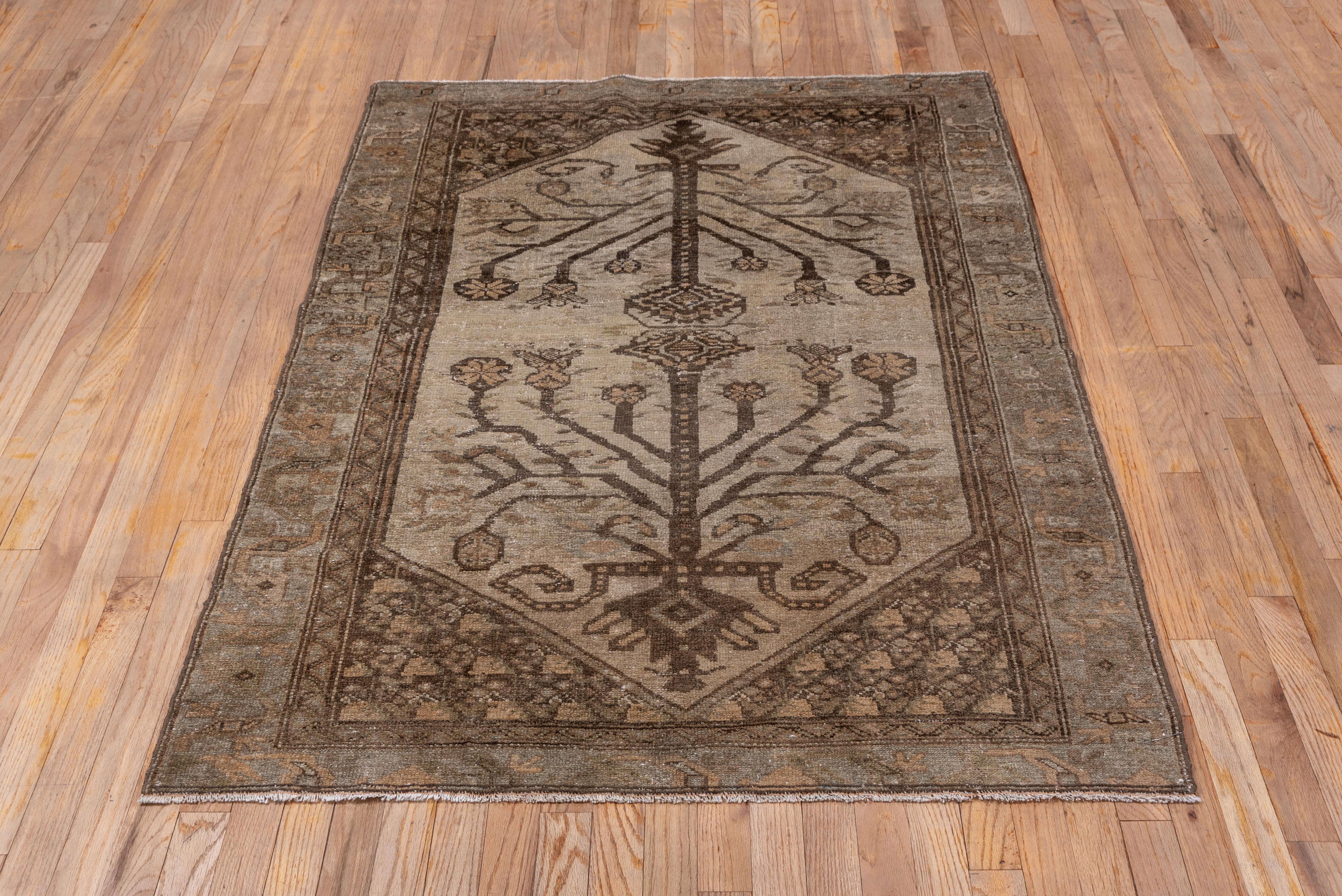 This earth-toned west Persian scatter shows a light tan field with a two way design of stylized flowering stems ending in rough palmette finials. The mid-brown corners show small flowers and the tan border has a discreet 'dragon vine' pattern.