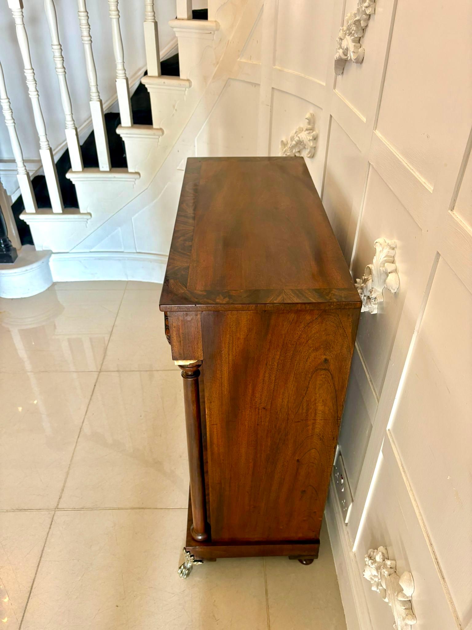 A superb quality early 19th-century antique Regency period figured mahogany chiffonier cabinet of elegant and compact proportions.

The rectangular top is veneered in beautifully figured mahogany with crossbanded edging over a pair of panelled doors