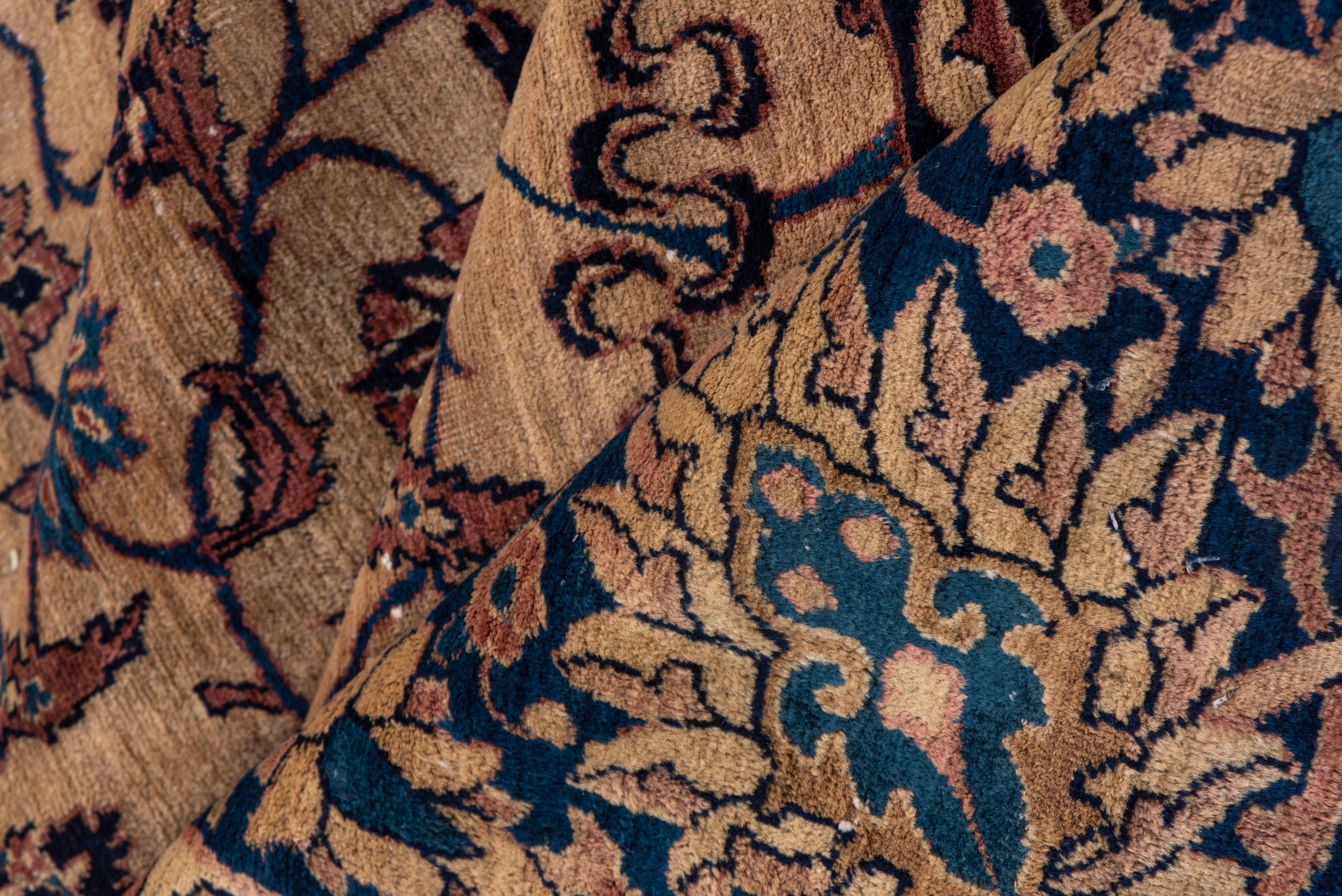 Made for the European market, this west Persian village carpet in an urban style shows a cream field with a finely detailed palmette, vine and cloud band design in shades of lighter blue, framed by a royal blue palmette and vermiculate cloud band