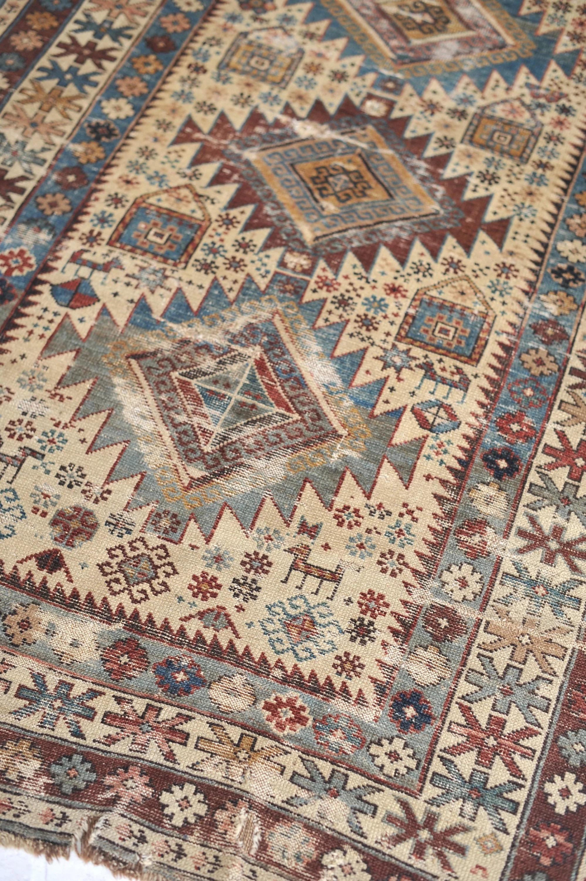 Ophelia Beautiful Mix of Tribal  Geometric & Bohemian  Floral Design  Ophelia Fine Antique Shirvan Caucasian Rug, circa 1890

Size: 3.5 x 4.11
Age: Circa 1890
Pile: Low. A lot of wear and tear. Thread bare in spots. Small holes and antique