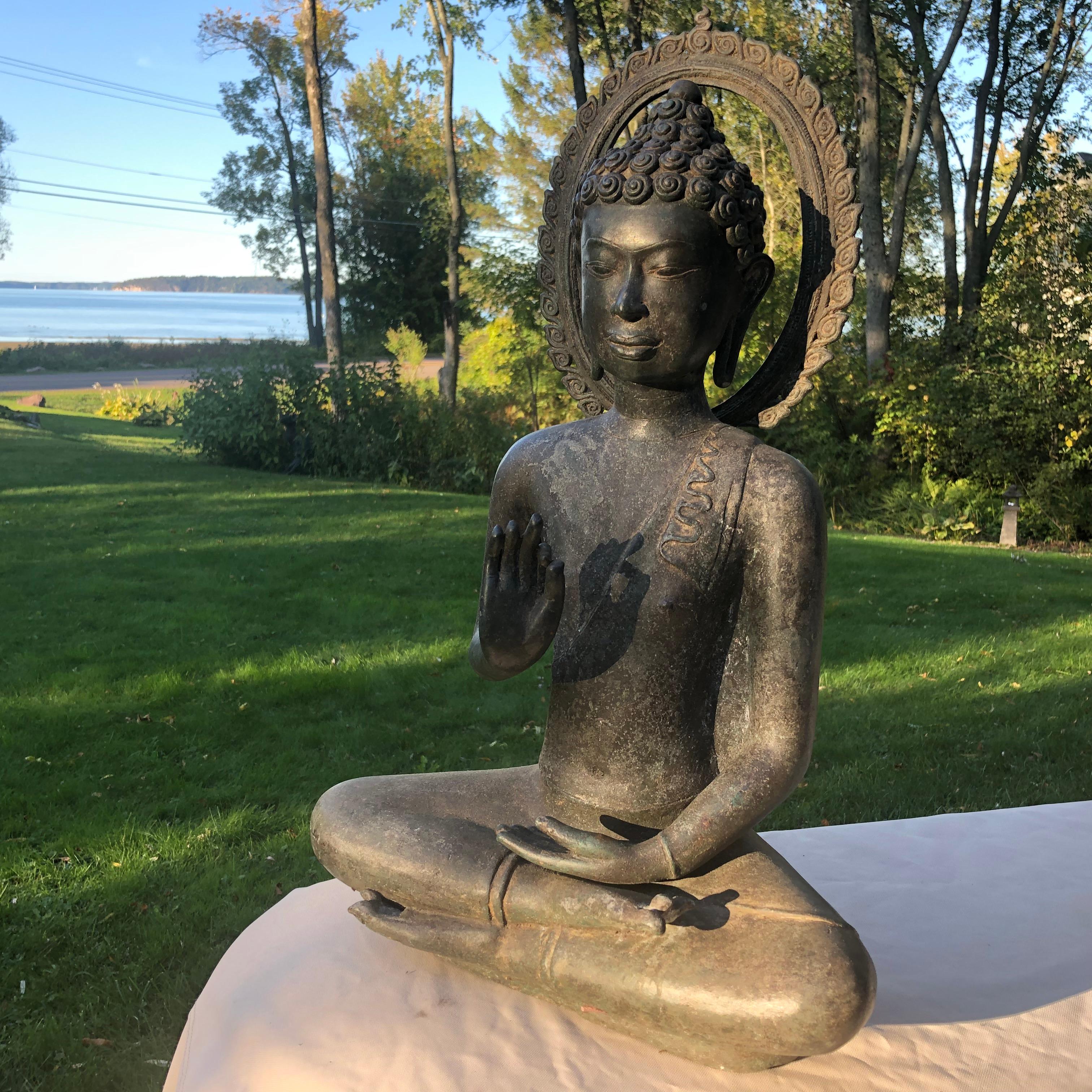 From a forty year old private United Kingdom collection

A Lovely Buddha seated in the padmasana or full lotus position, with his hands raised in front of his chest in the dharmachakra mudra- teaching or preaching the