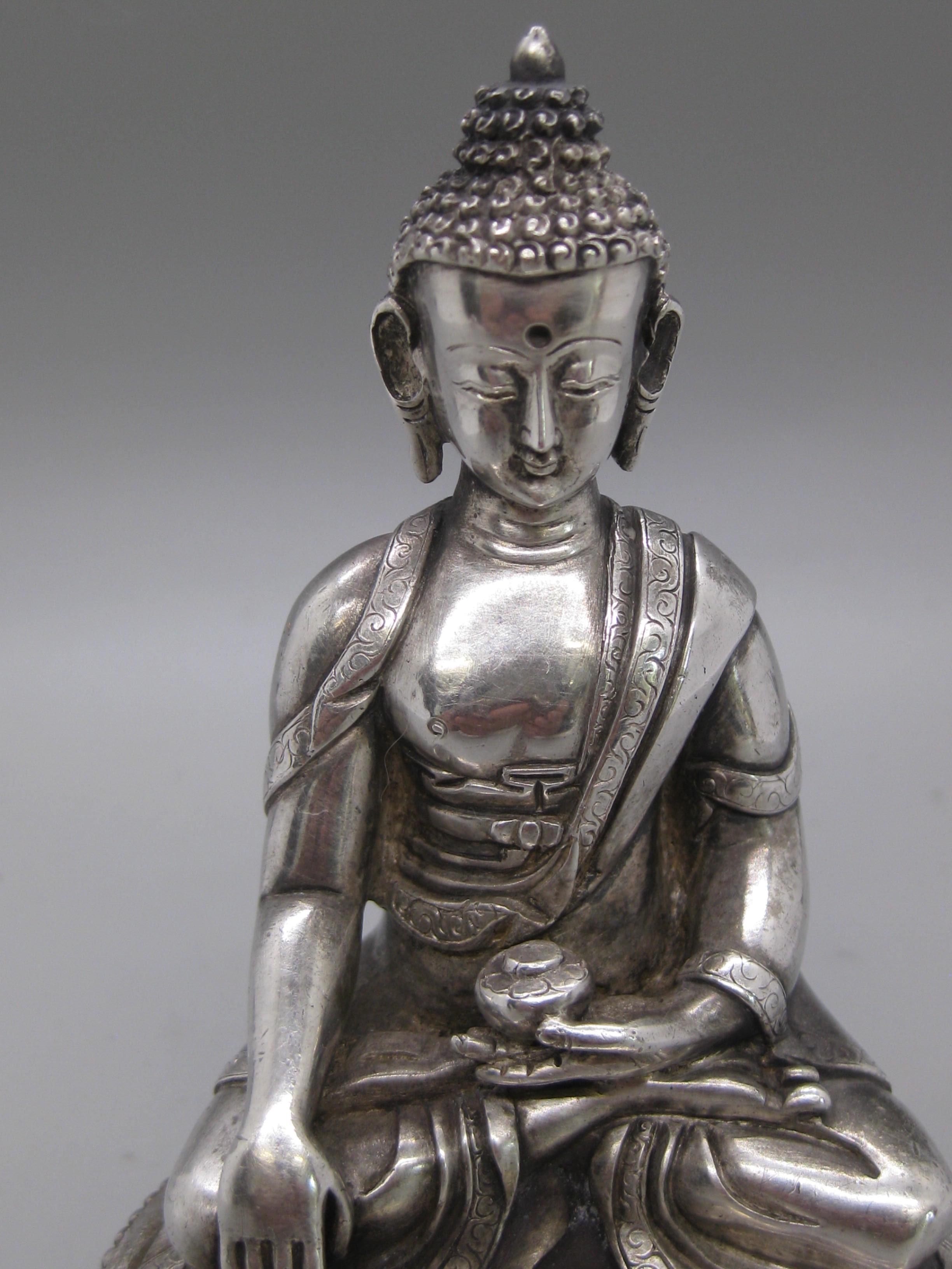 Fine antique Tibetan/Nepal sterling silver Shakyamuni buddha statue. The buddha tests at least .925 sterling silver and might be a higher purity silver. I pulled the base cover off to show there is no filler for weight. Very high quality with