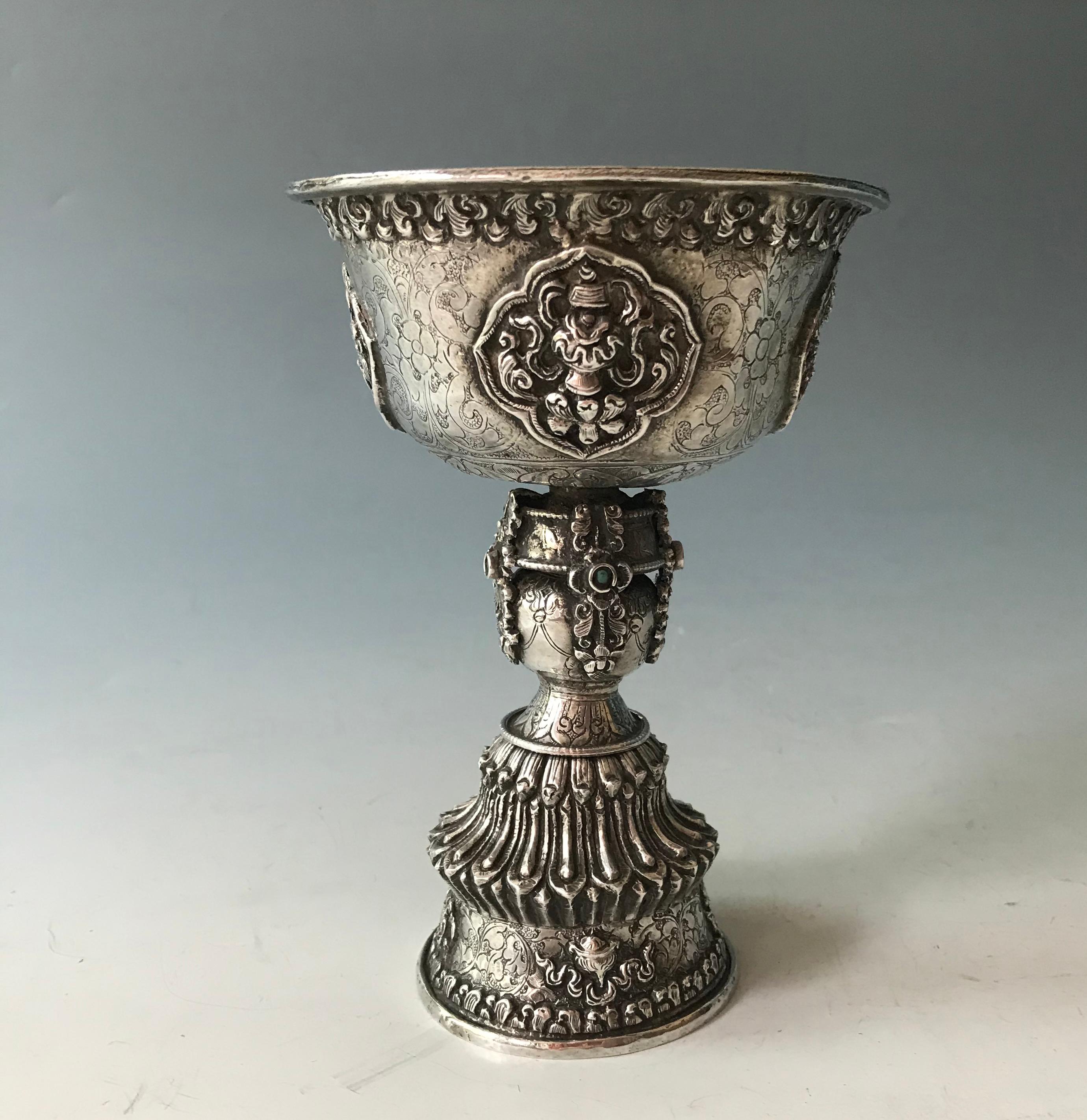 Fine Antique Tibetan ritual silver butter oil lamp.
The Yak butter Oil lamp used in Tibetan rituals 
Very finely made in high grade silver with hammered chased and repoussé Buddhist designs all over. 
Height 6 1/2 x 4 1/2 inches , 16 x 11