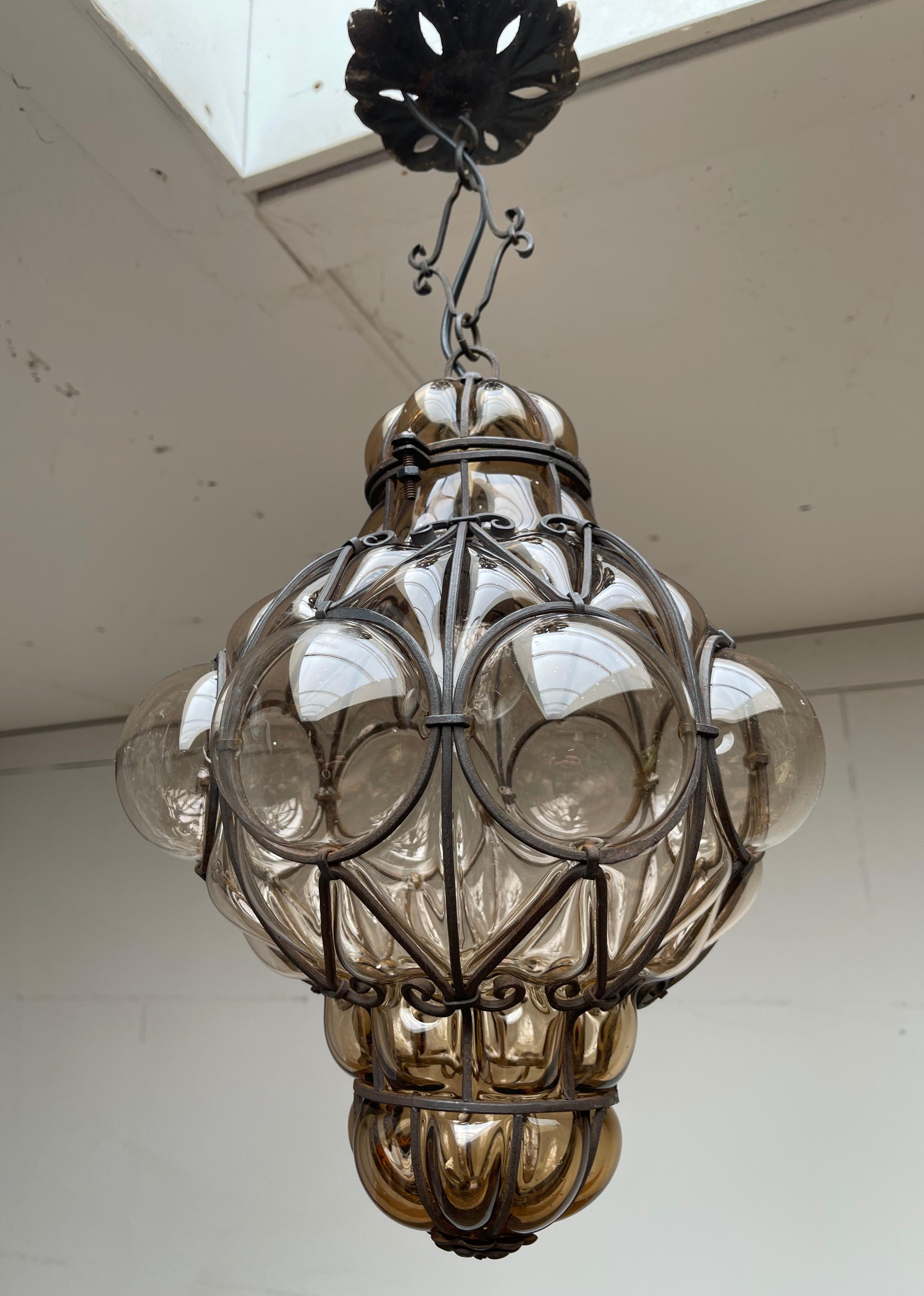 Good size and great condition light fixture. 

This Venetian pendant is in excellent condition. The thick shade of this smoked glass pendant is perfectly and symmetrically mouth blown into the hand crafted metal frame and the result is an absolute