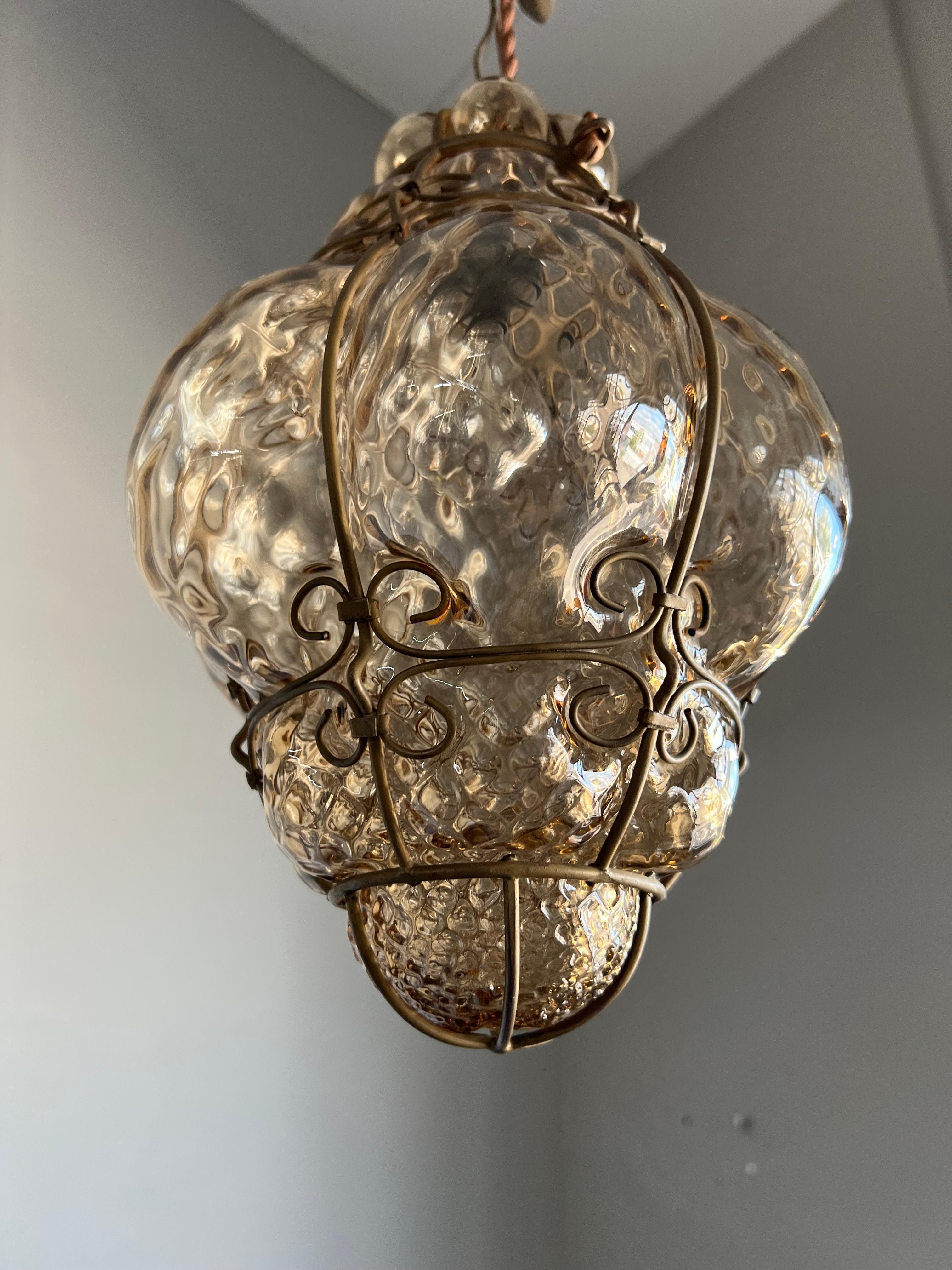 Good size and great condition light fixture. 

This Venetian pendant is in excellent condition. The thick shade of this smoked glass pendant is perfectly and symmetrically mouth blown into the hand crafted metal frame and the result is an absolute