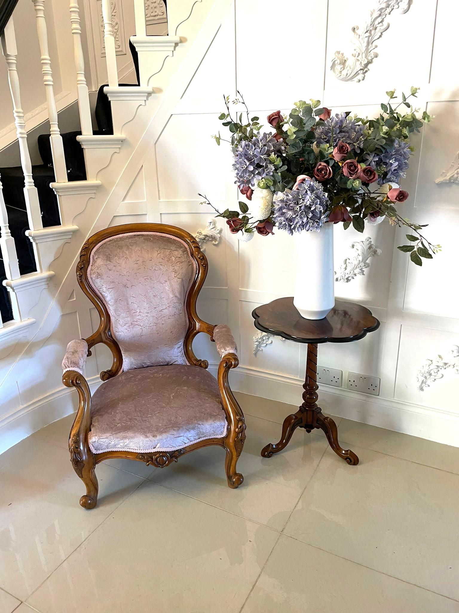Fine antique Victorian carved walnut armchair with elegant carved detail to the top and pretty carved shaped arms and carved front rail. It stands on shaped carved cabriole front legs with out-swept back legs. It has been newly reupholstered in a