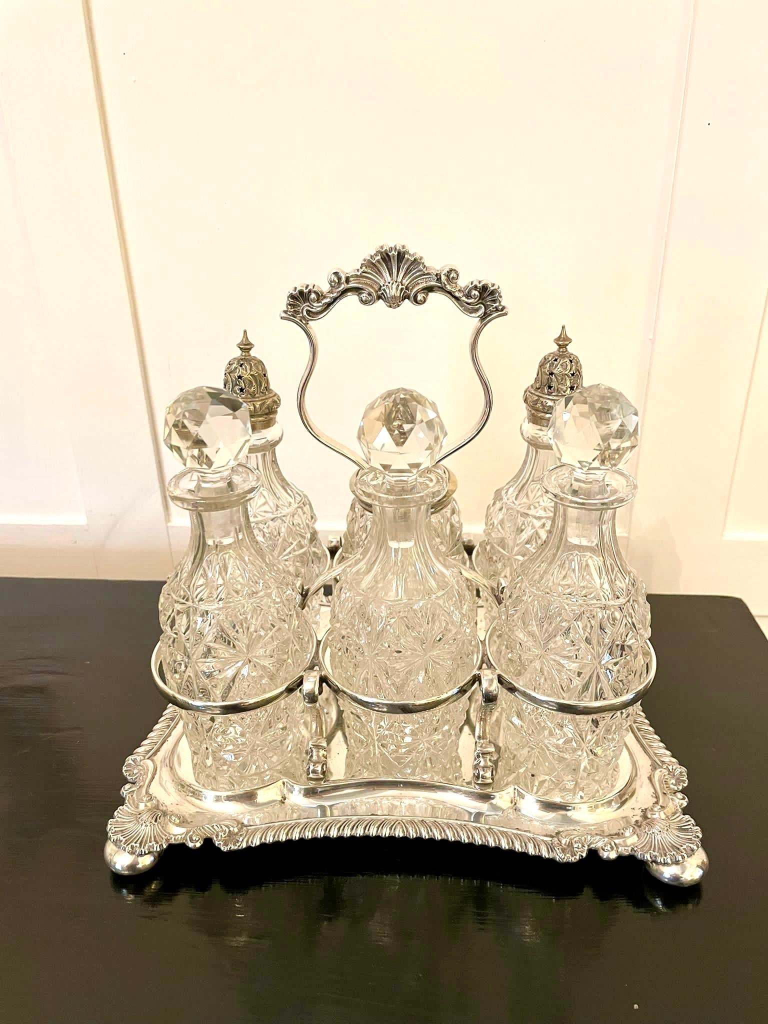 Fine antique Victorian silver plated six bottle cruet set having six beautiful quality cut glass bottles with original glass stoppers and stunning ornate silver plated tops. They are standing in a magnificent ornate silver plated stand raised on