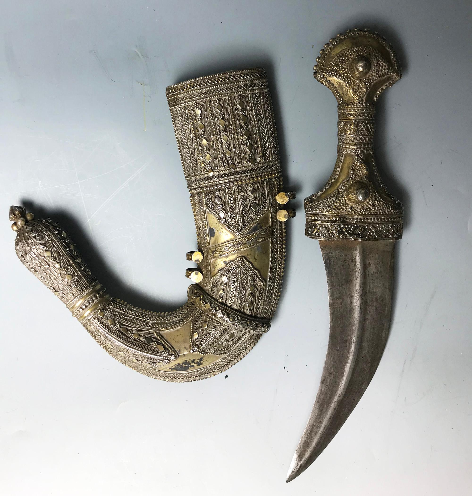 A Rare Large Antique Jambiya Dagger with highly ornate silver work with added gold gilding
A superb example of a middle eastern Jambiya
Height 38 cm

 Yemeni, Saudi or Omani
   