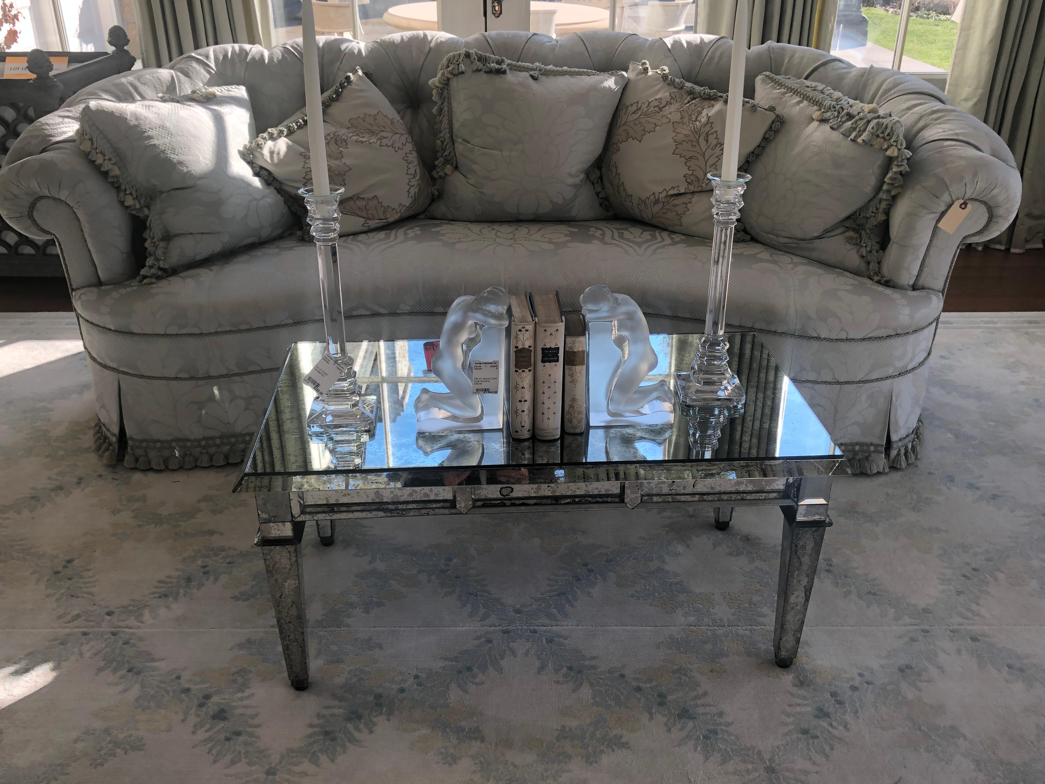 Fine antiqued mirror glass coffee table in Hollywood Regency style. This is a stunning antiqued mirror coffee or low table recently purchased from a fine Greenwich CT Mansion. All of the mirrored pieces are separately cut and inserted in a wooden