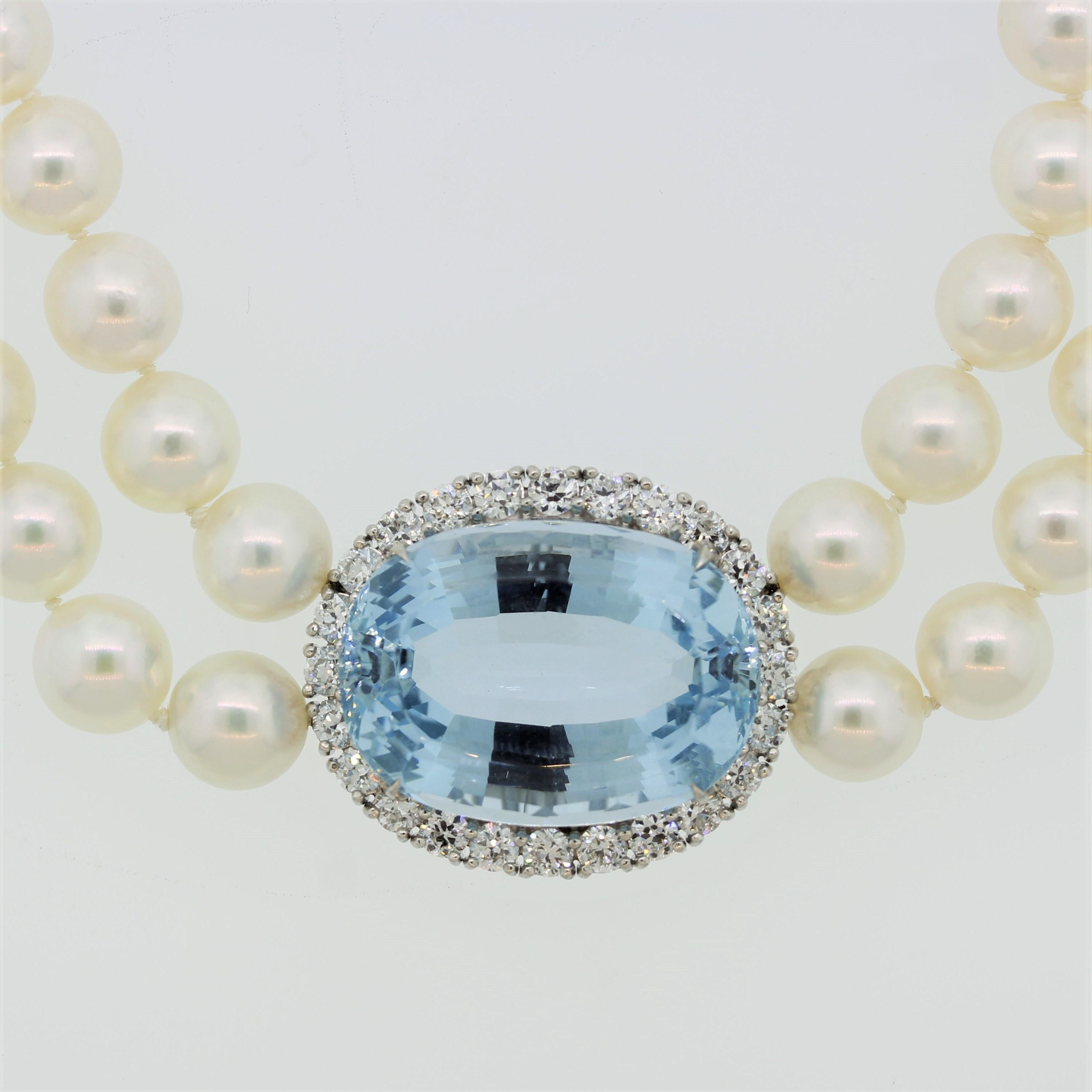 A stunning piece featuring a stunning oval-shaped aquamarine weighing 48.72 carats. It has the ideal bright sea-blue color and is free of any inclusions allowing the stones natural brilliance to shine. It is surrounded by 0.63 carats of larger round