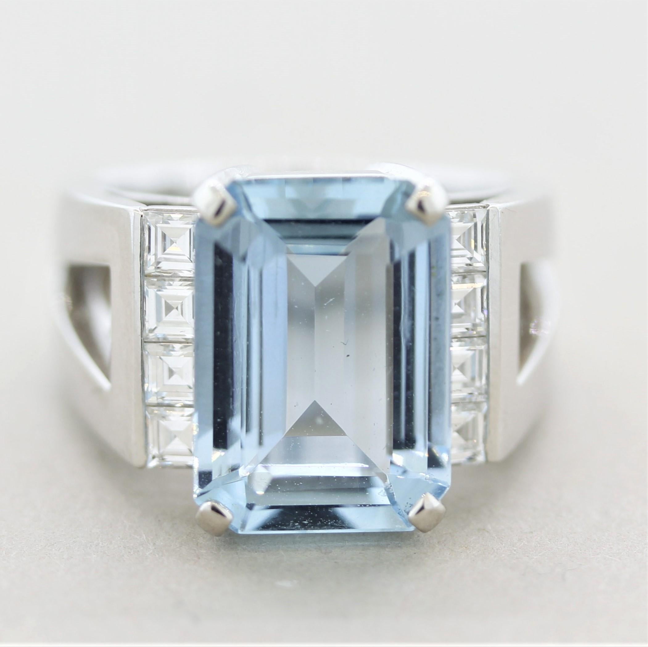 A superbly crafted gemstone ring featuring a classic 5 carat aquamarine with a bright open sea-blue color. It is accented by 8 asscher-cut diamonds channel-set on its sides and weighing 0.50 carats. The ring itself is expertly crafted as it weighs
